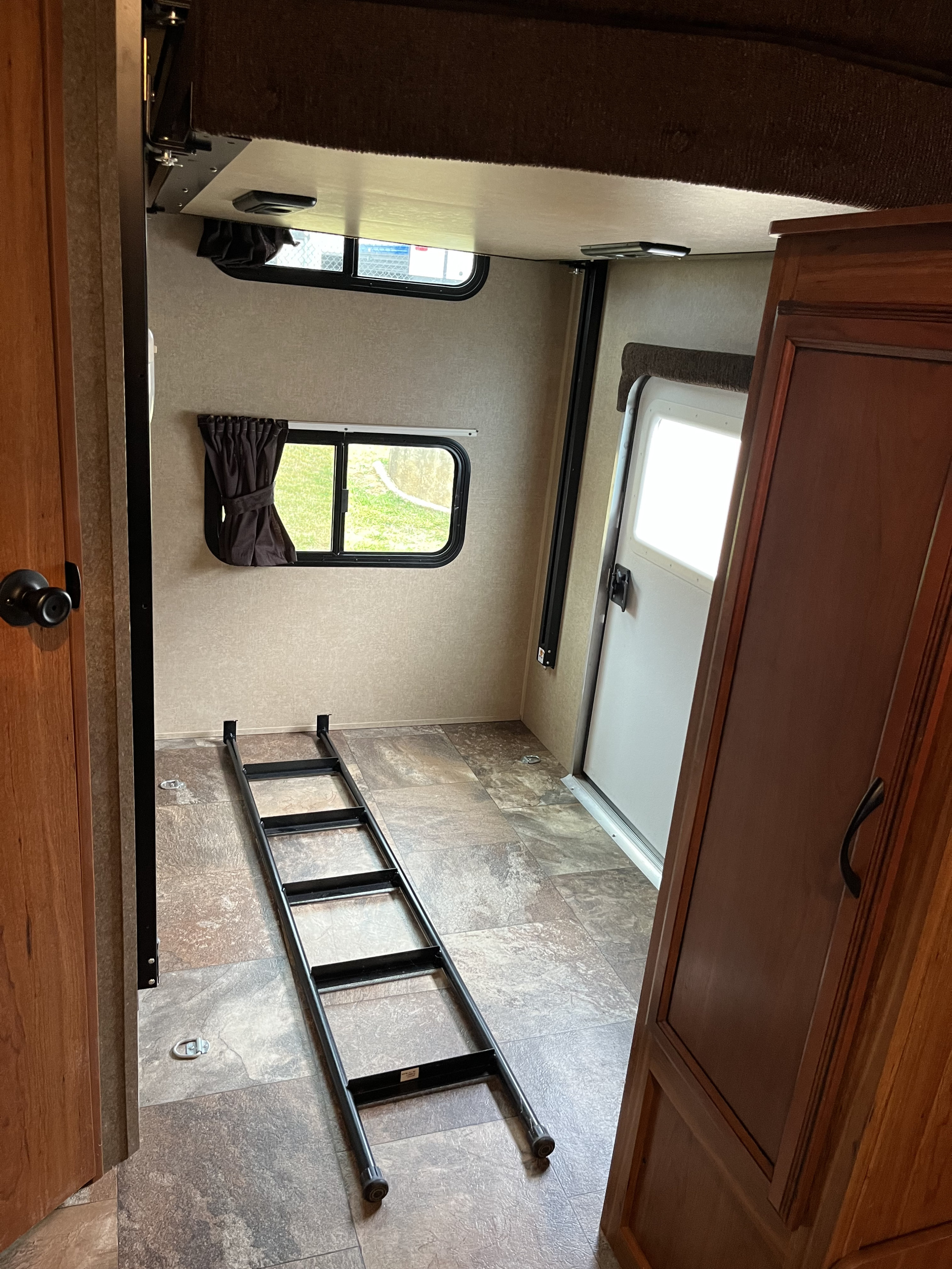 Inside an RV rental: Features include a bunk bed, portable ladder, exterior door, and floor tie-downs.. Starcraft Launch Ultra Lite 2015