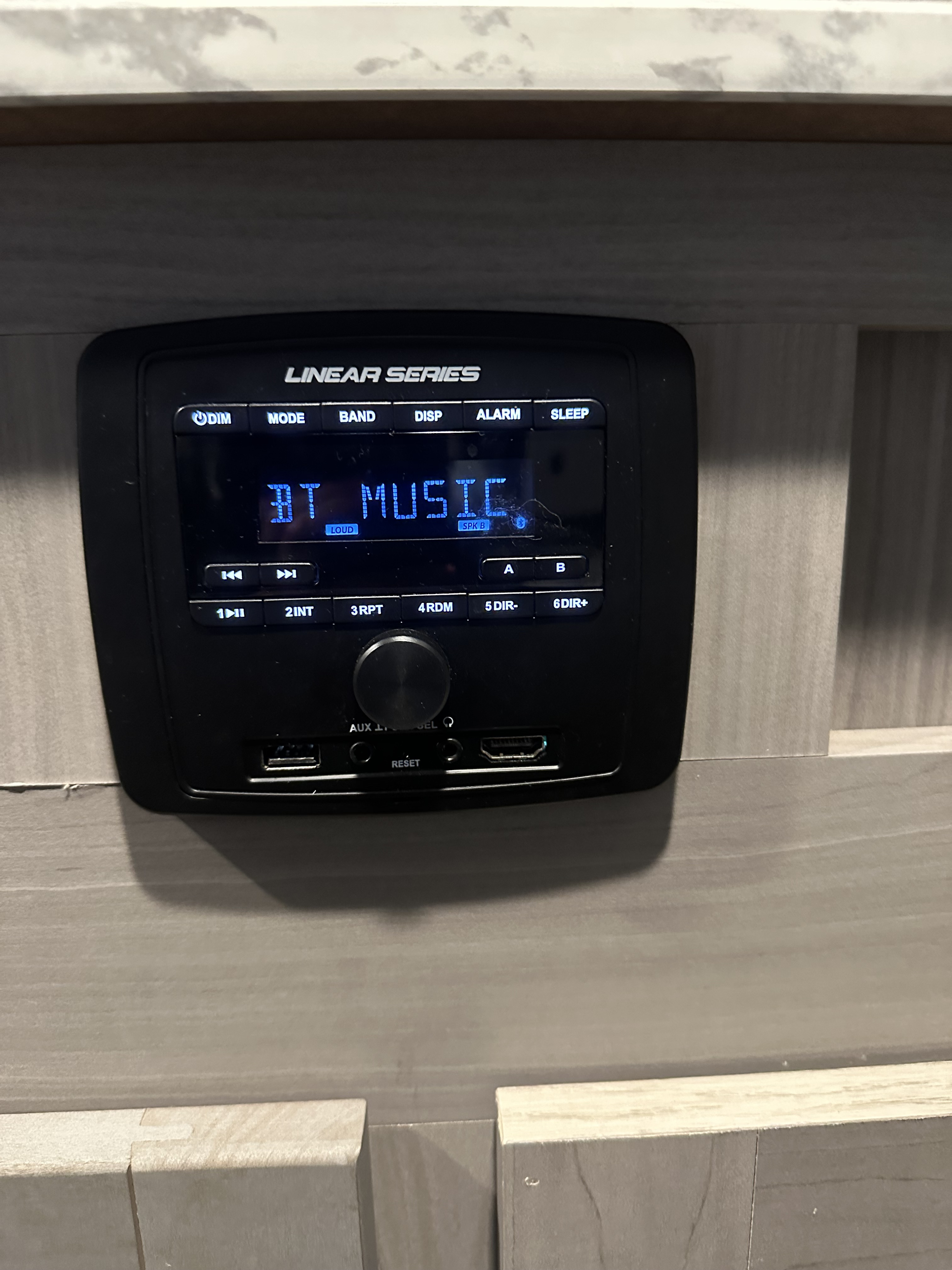 This RV rental's Linear Series stereo displays "BT MUSIC" mode, featuring controls, USB, AUX, and HDMI ports.. Dutchmen Coleman 2022
