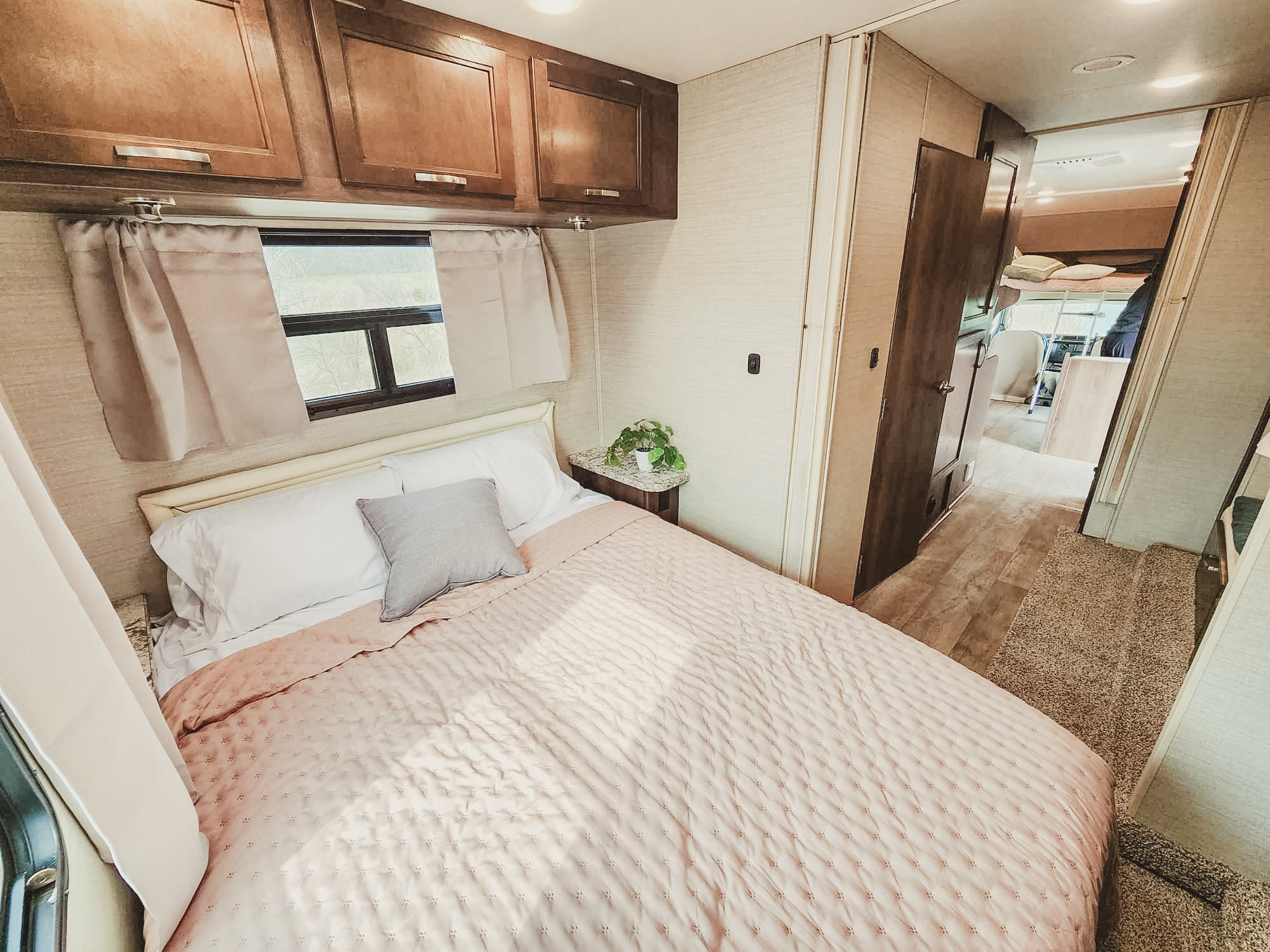 Relax in this comfortable RV rental bedroom, featuring a plush bed, ample storage, and a bright, inviting interior for your next road trip.. Jayco Redhawk 2019
