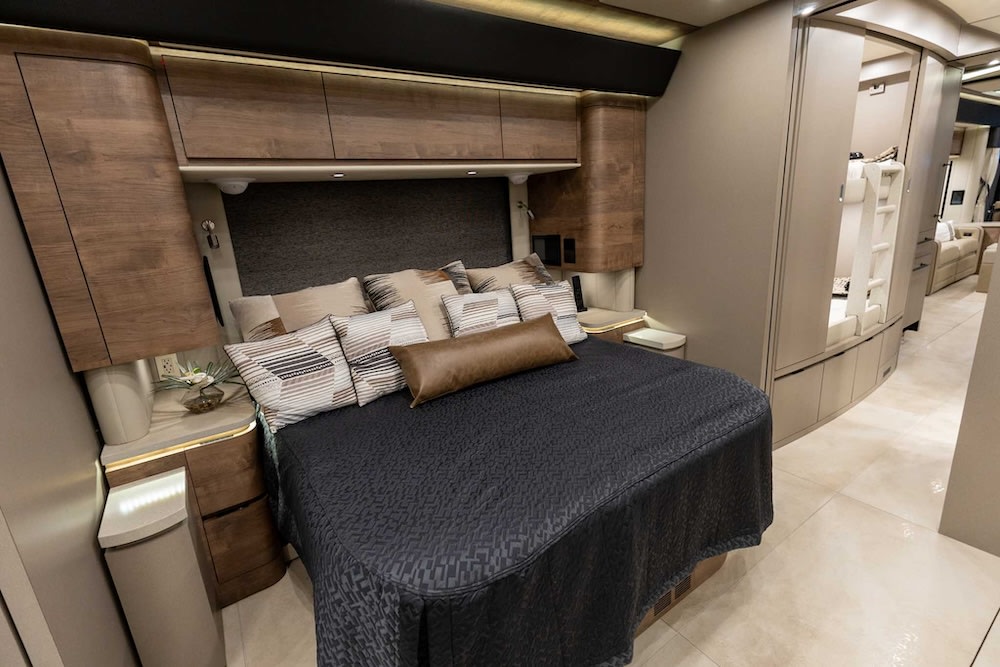 Spacious RV rental features a luxury bedroom with a queen bed and convenient bunk beds for families.. Newell Coach P50 2024
