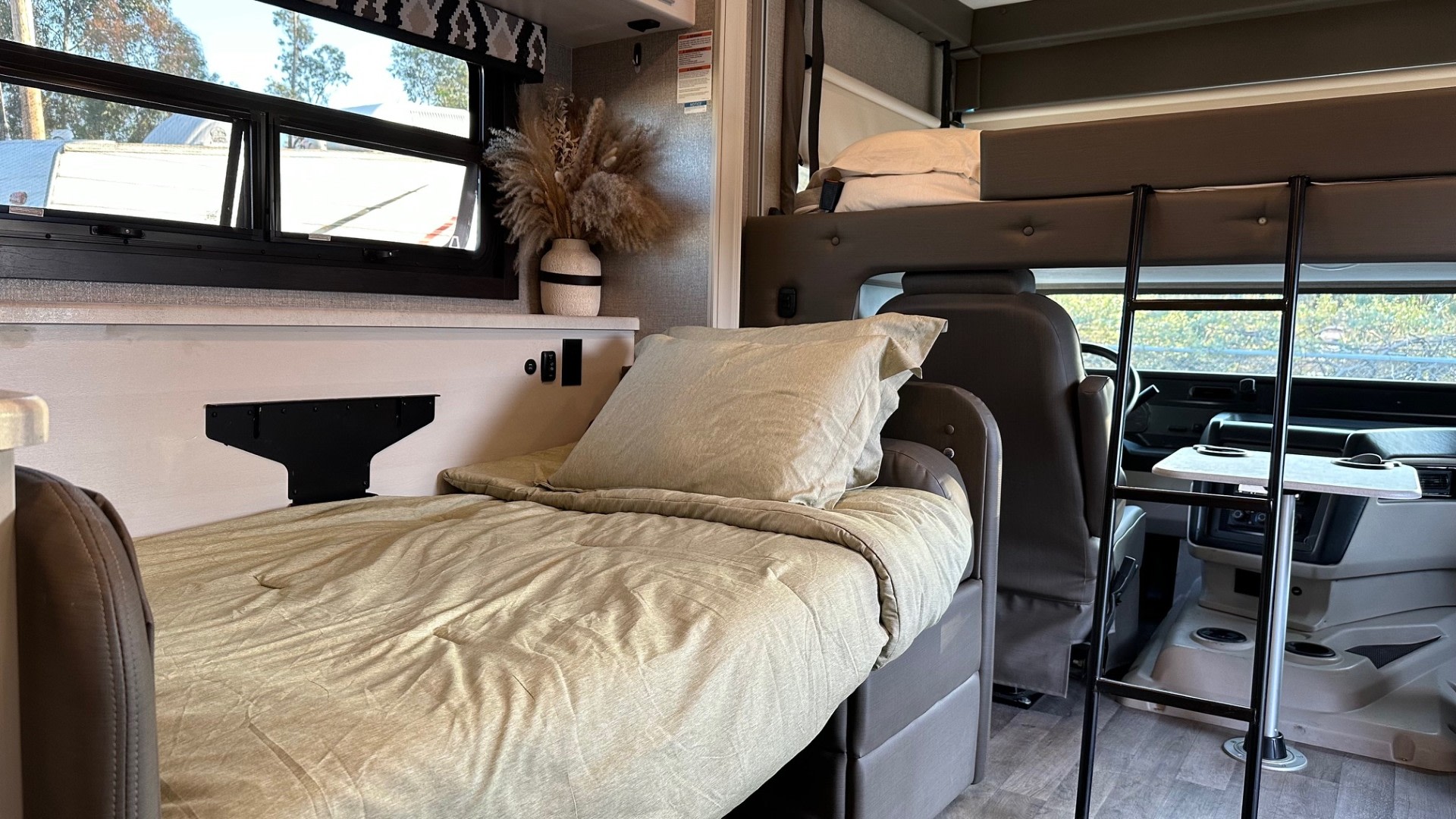 Cozy RV rental interior with bunk beds, a comfy bed, and a well-appointed living space. Perfect for your next road trip.. Jayco Alante 2021