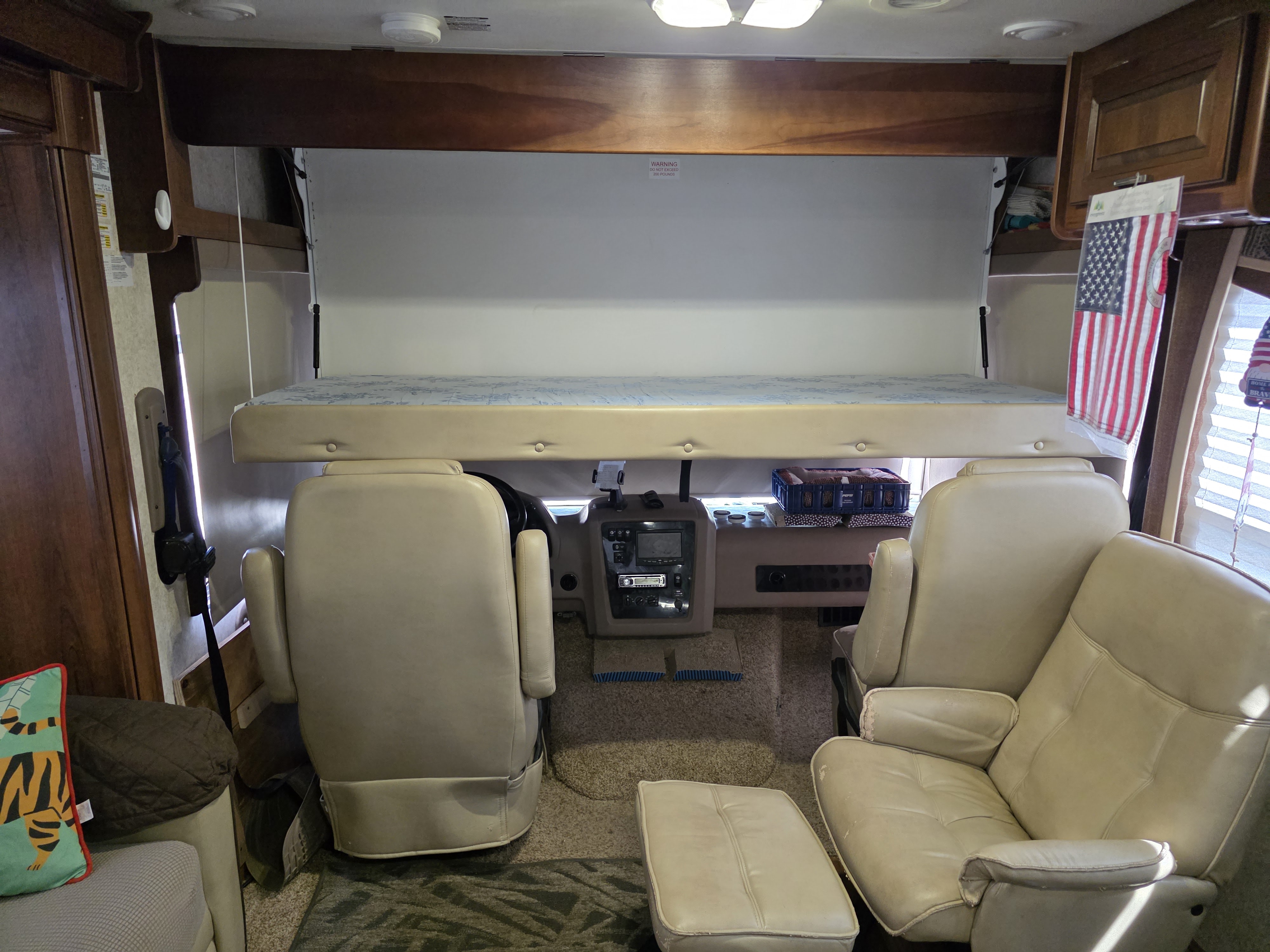 Inside an RV rental: bunk bed lowered over the cockpit, highlighting versatile motorhome sleeping and driving space.. Georgetown Georgetown Motorhome 2014