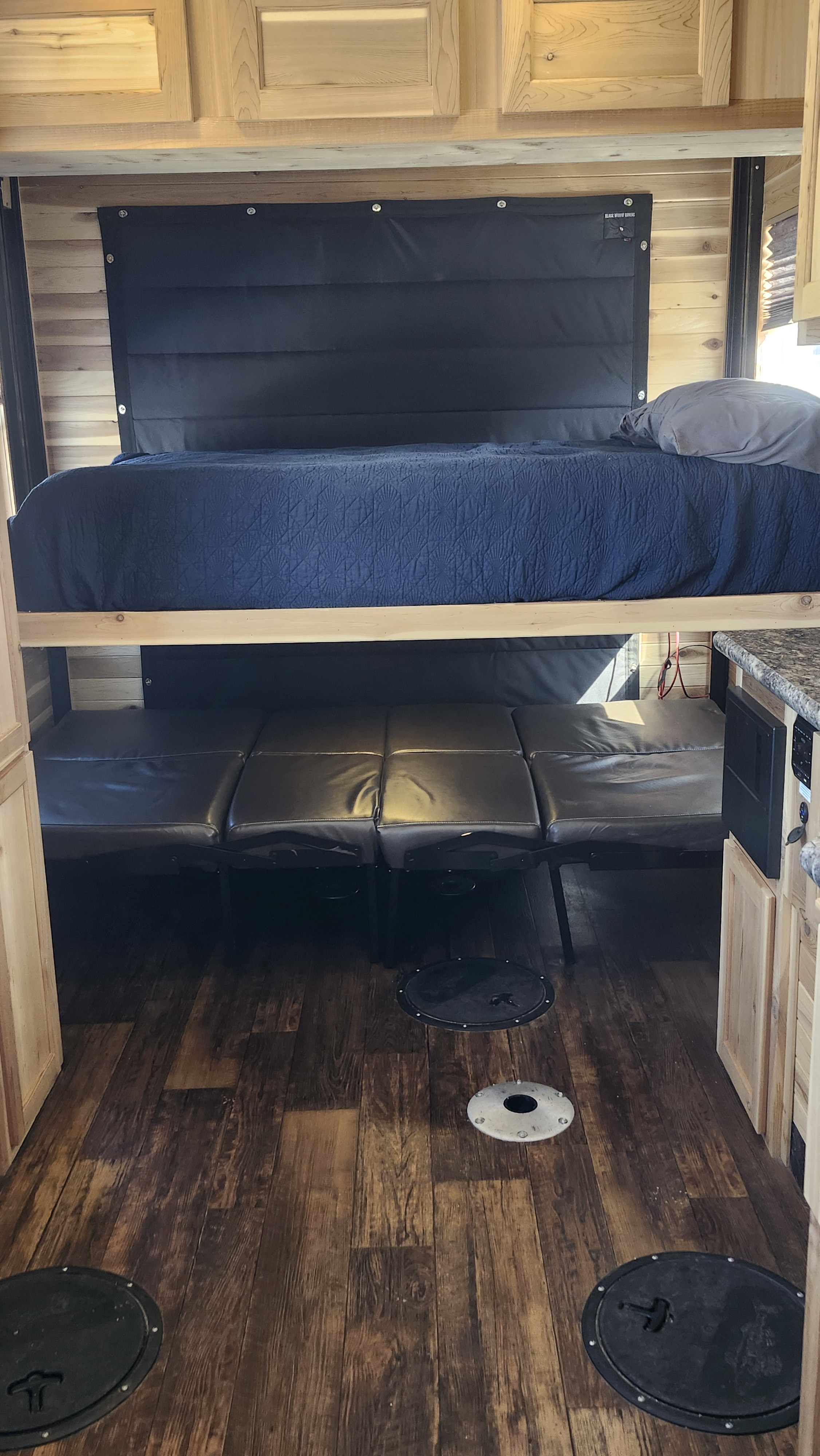 Versatile RV rental interior with bunk bed, sofa, and floor openings. Perfect for adventure, including ice fishing!. Ice Castle Fish Houses Toy Hauler 2022