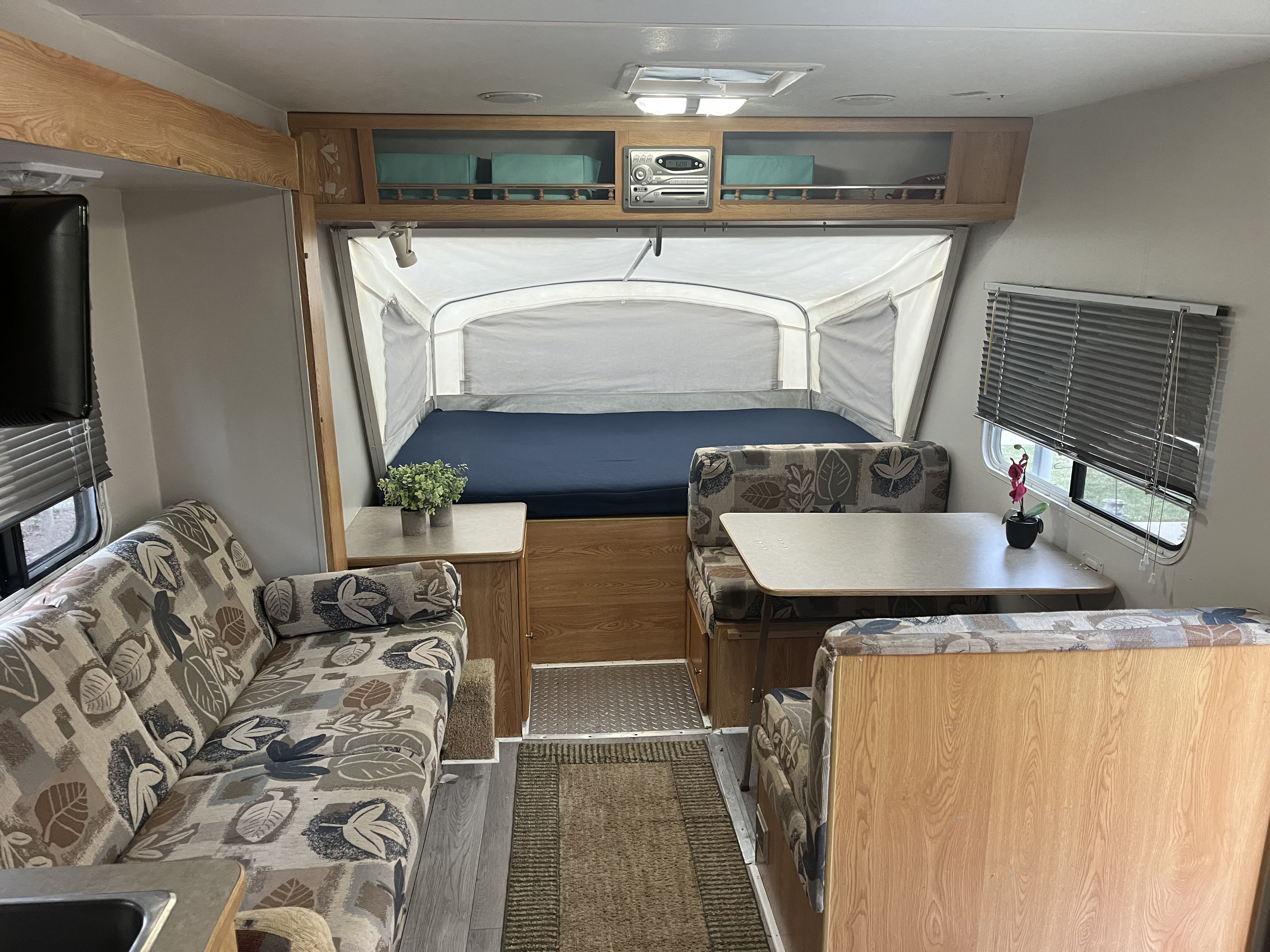 Inside a comfortable RV rental: pop-out bed, dinette, and sofa create a welcoming living space for your adventures.. R-Vision Trail-Lite Bantam 2003