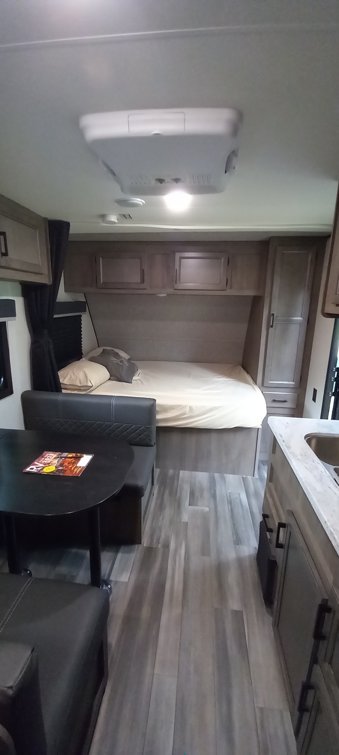 Spacious RV interior with bed, dinette, and kitchen area, perfect for a comfortable rv rental experience.. Starcraft Autumn Ridge 2022