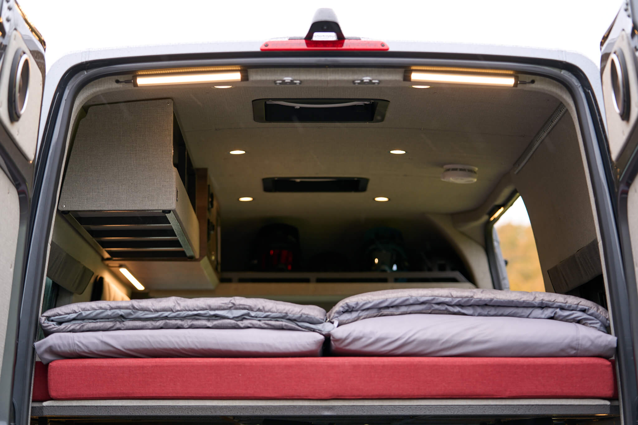 Experience comfort in this RV rental's spacious interior. Features include a comfy bed, overhead cabinets, and bright lighting.. Mercedes-Benz Sprinter 2022