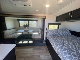 Spacious RV rental interior with a cozy dinette, comfortable bed, and modern amenities for your next adventure.. Forest River Cherokee Wolf Pup 2023