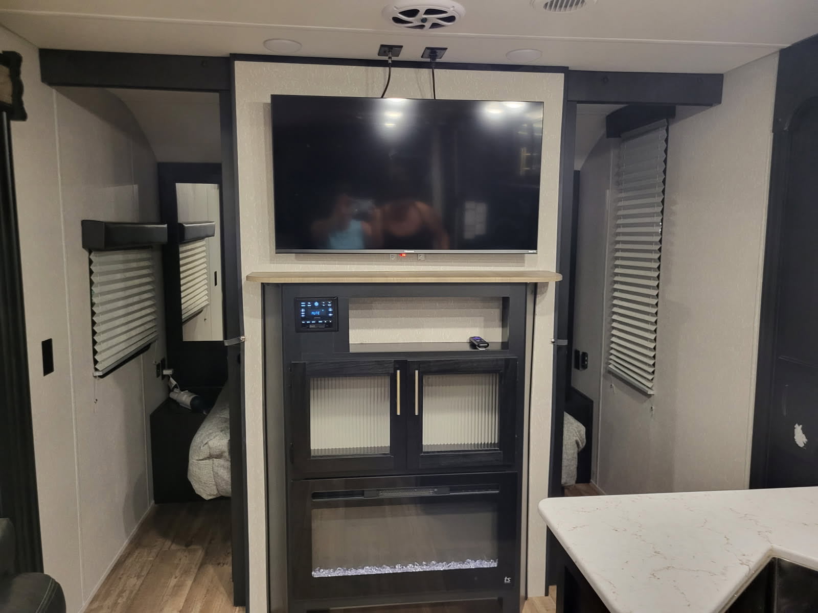 This RV rental features a modern entertainment center with TV & electric fireplace, flanked by private sleeping quarters.. Cherokee Grey Wolf 2022