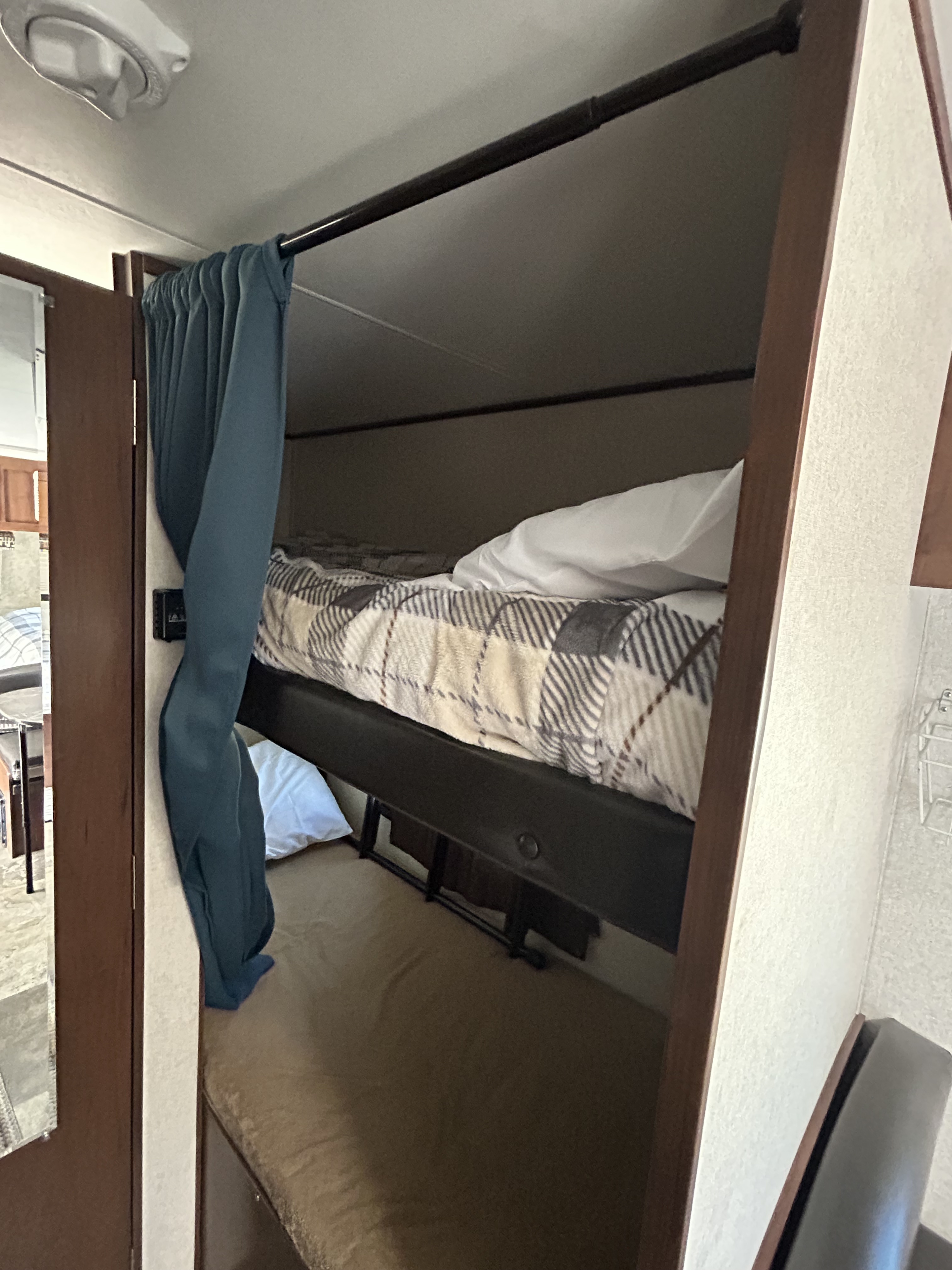 Cozy RV rental bunk beds with a privacy curtain and soft bedding, perfect for family travel.. Jayco Jay Flight SLX Baja Edition 2017