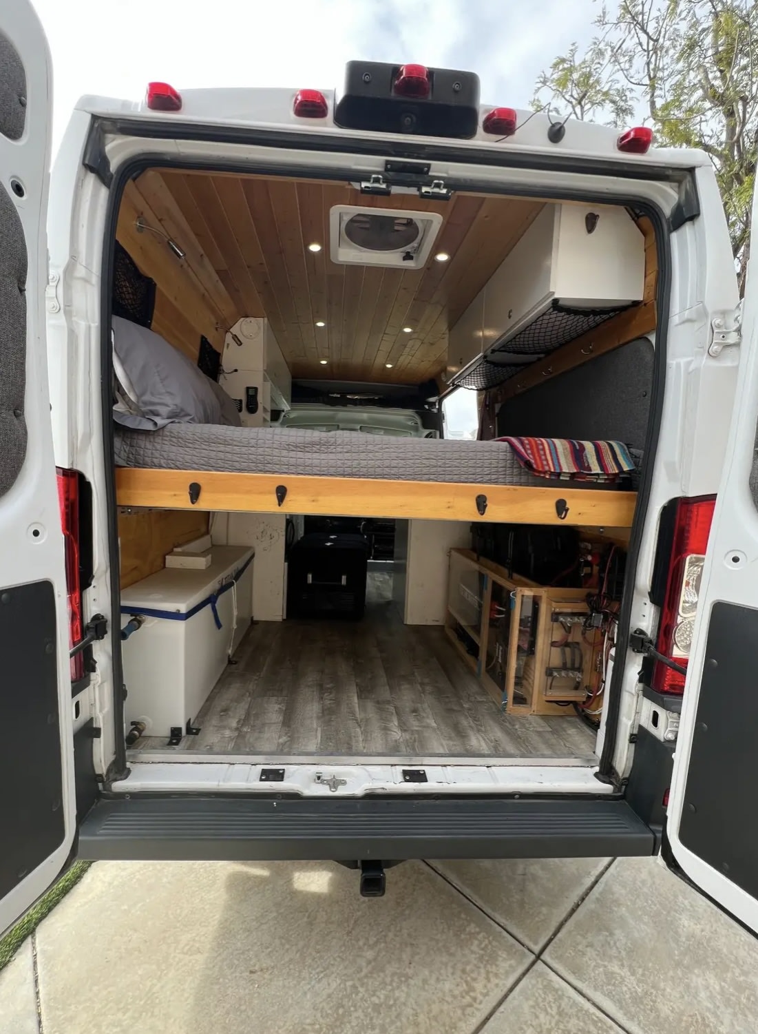 Explore comfort in this custom camper van rv rental! Features elevated bed, wooden interior, and smart storage.. Dodge 1500 2018