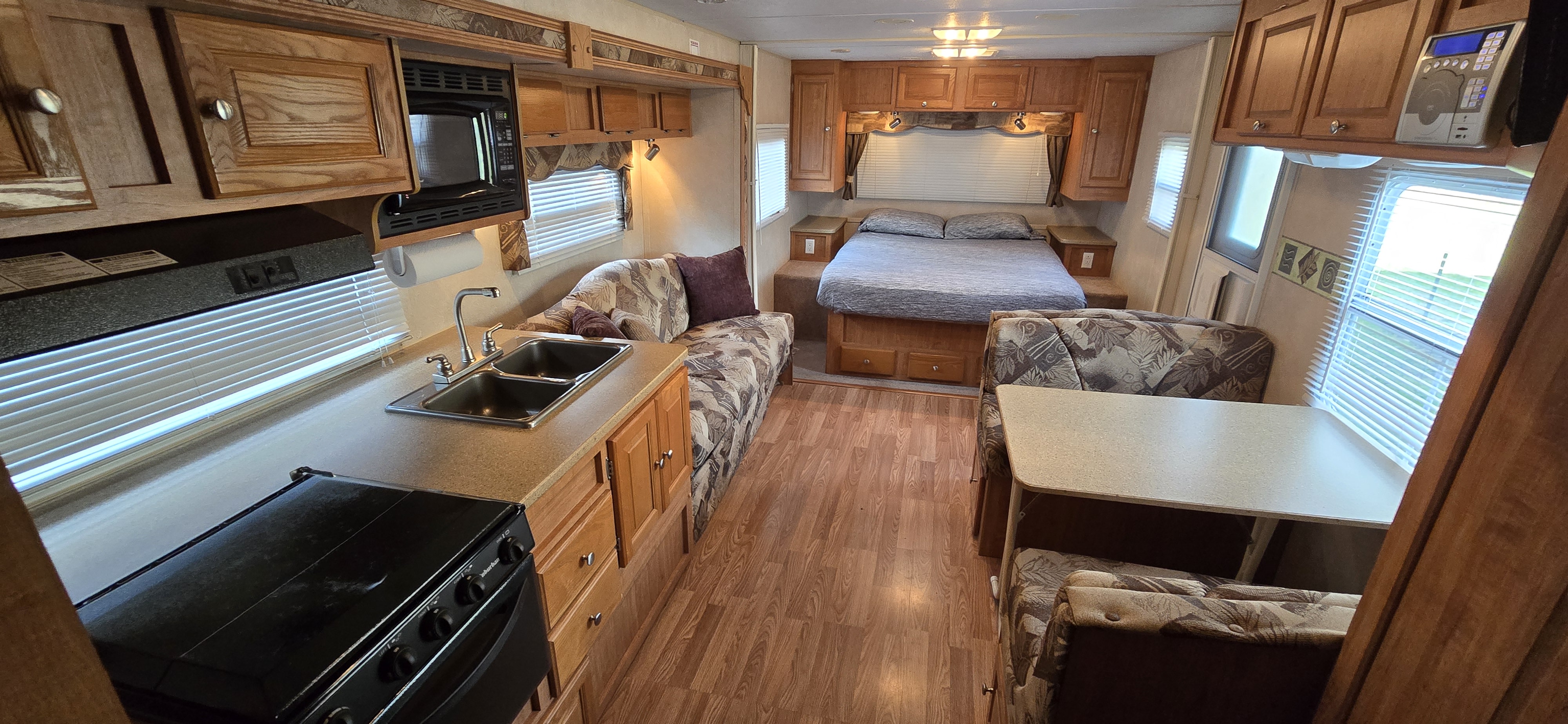 Spacious RV rental interior featuring a full kitchen, comfortable bedroom, and dining area. Perfect for your next adventure.. Forest River Flagstaff Super Lite 2008