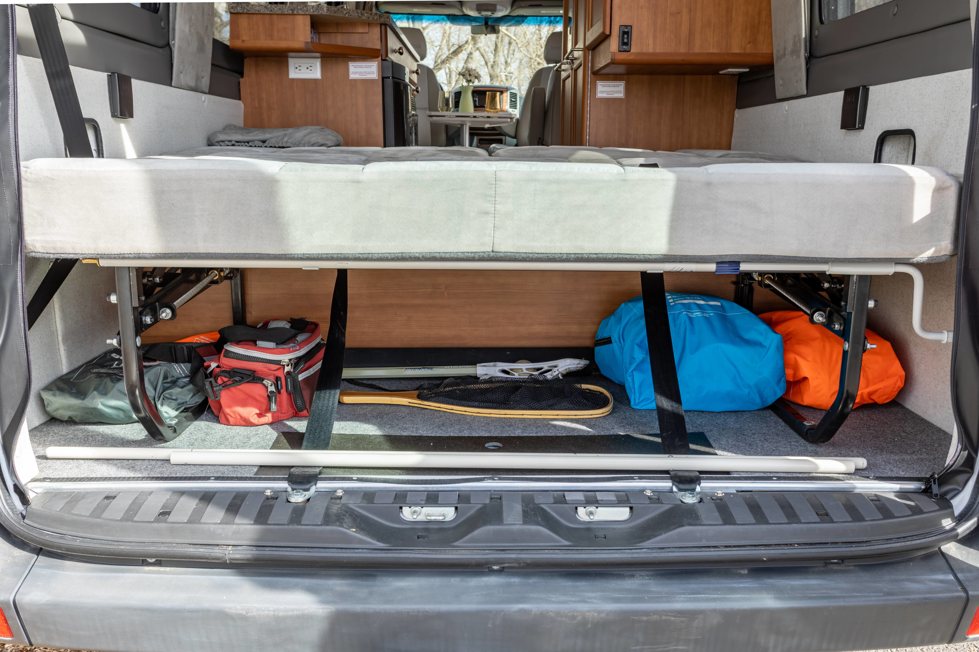 RV rental interior features a high-lift bed over spacious under-bed storage, accessed from the rear.. Roadtrek Roadtrek Class B 2010