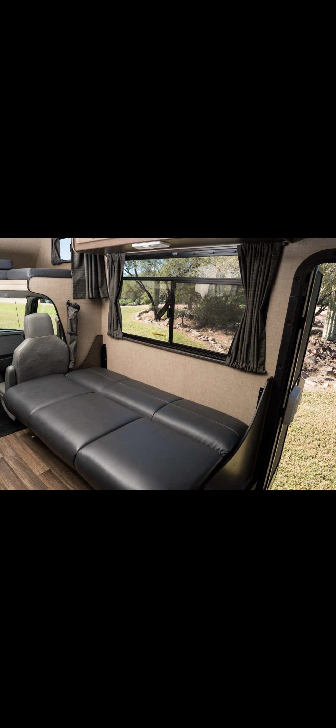 Enjoy an rv rental's spacious interior with a versatile sofa bed and scenic outdoor window view.. Thor Majestic 2020