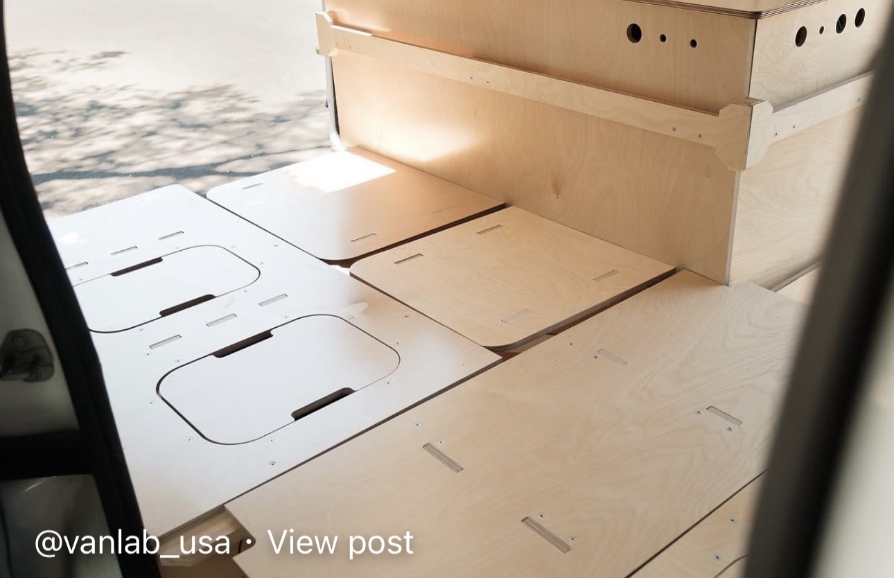 Modular plywood interior of an RV rental, featuring clever floor storage panels and custom cabinetry. Ideal for camper van adventures.. Ram Promaster City 2018