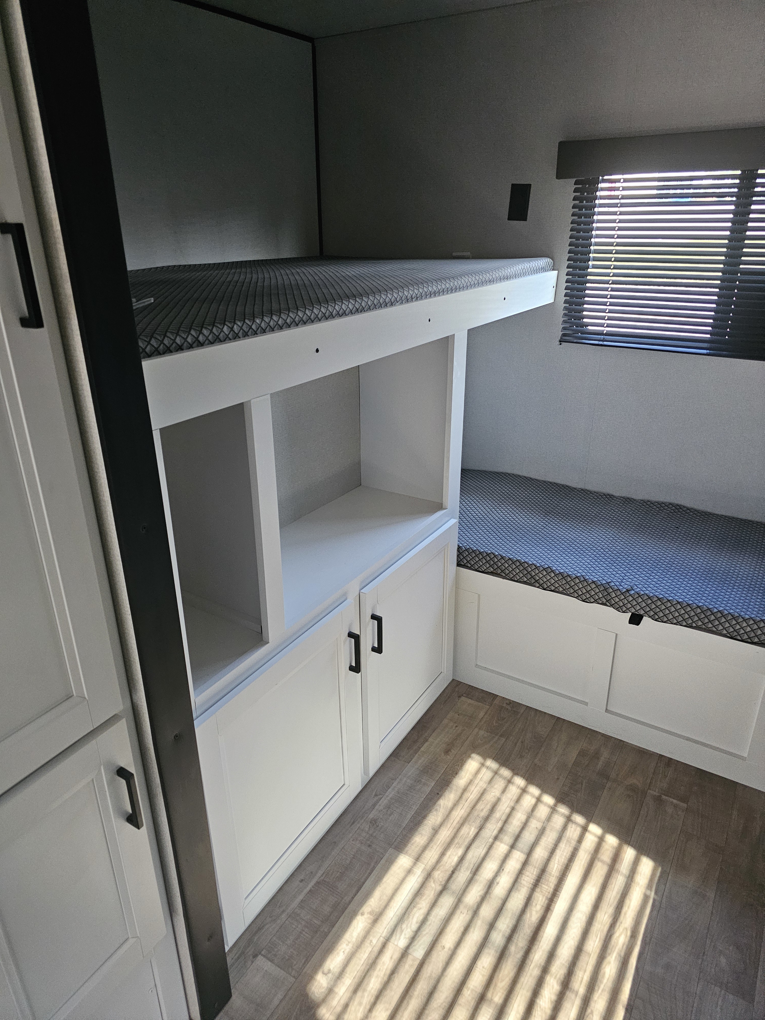 RV rental with cozy bunk beds, integrated storage, and a bright window with blinds, ready for your next adventure.. Keystone RV Hideout LHS 2022