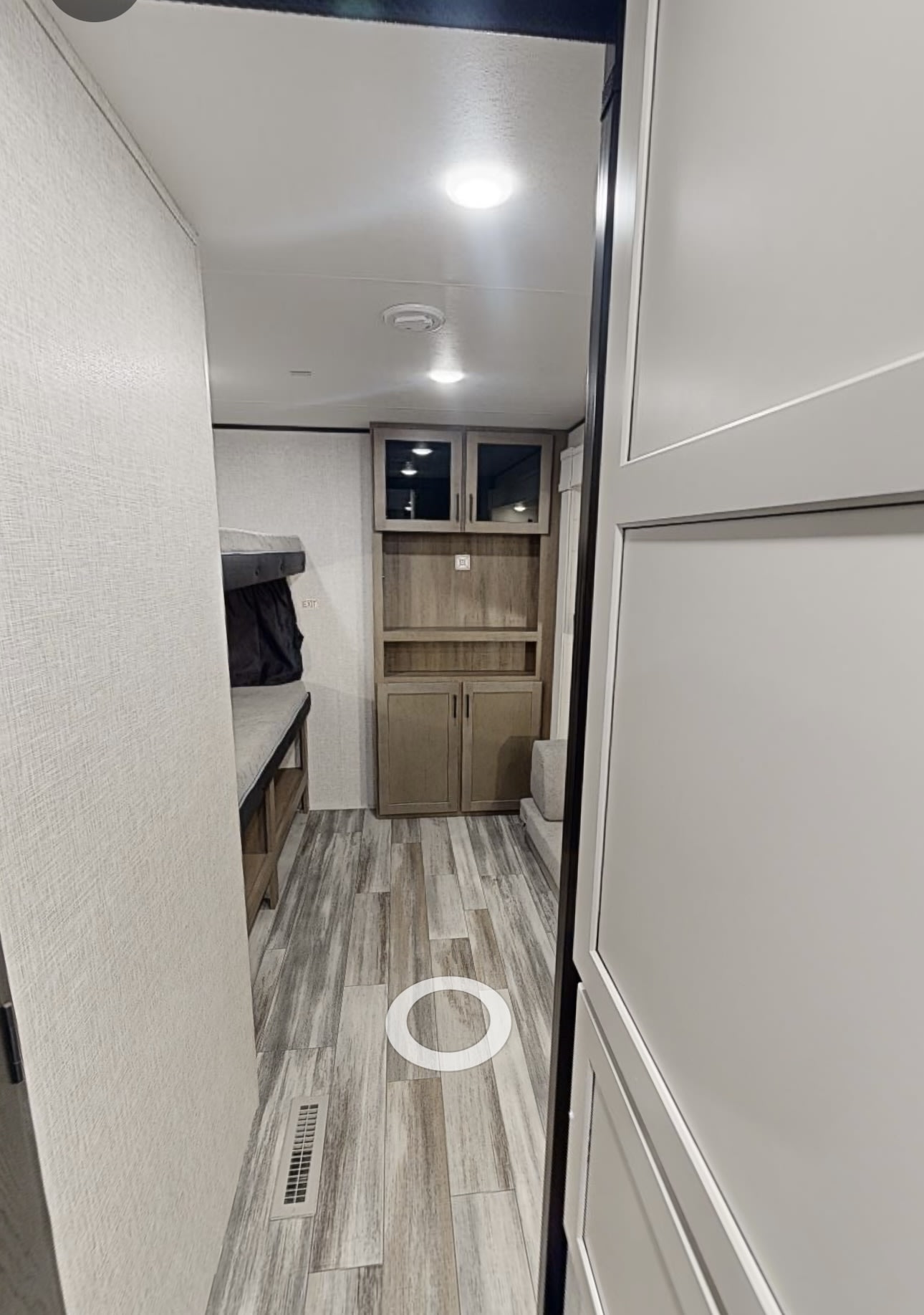 This RV rental interior features a compact living space with a bunk bed area and built-in storage cabinets.. JAYCO Jay Flight SLX 2025