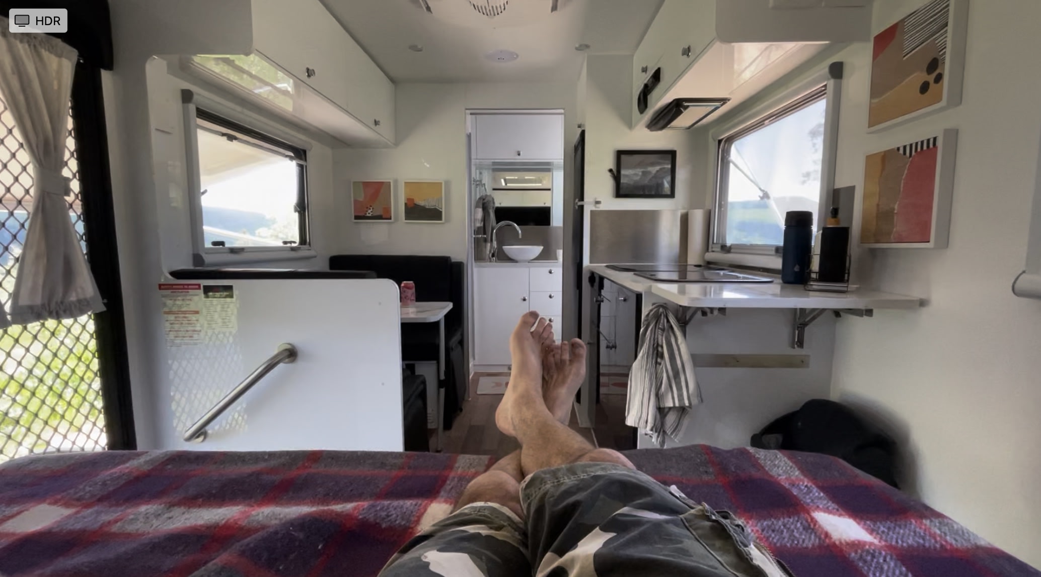 Enjoying an rv rental from the bed. This cozy interior features a compact kitchen, dining area, and large windows with scenic views.. MDC MDC Trailer 2022