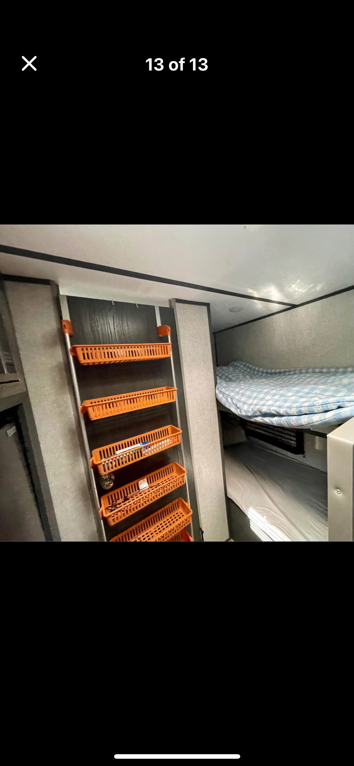 Cozy RV rental bunk beds with integrated hanging storage baskets for organized travel.. Aspen Trail LE 2022