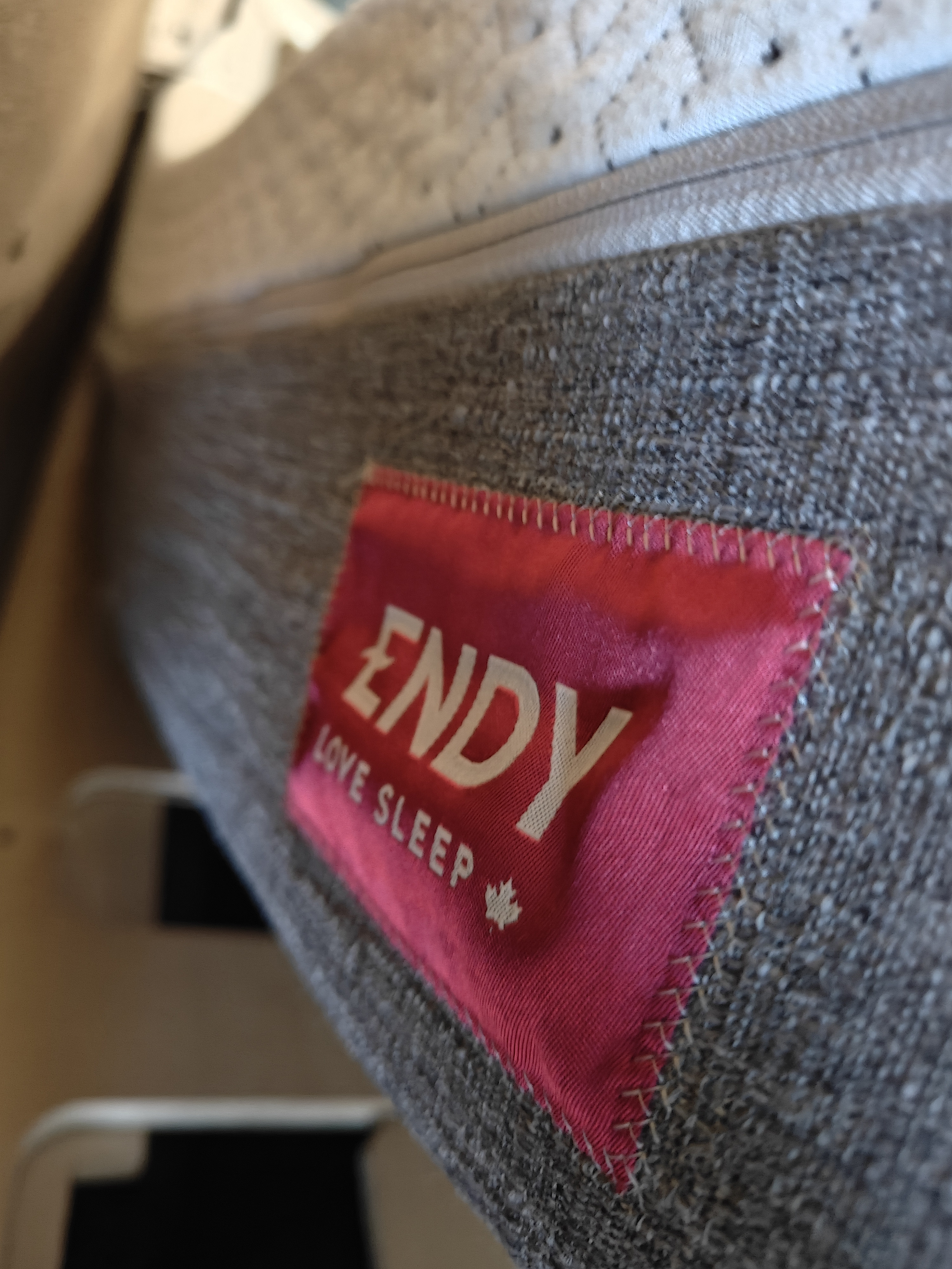 Close-up of an Endy mattress with its "ENDY LOVE SLEEP" label (red & white), providing comfort in an RV rental.. Mercedes-Benz Sprinter 2017
