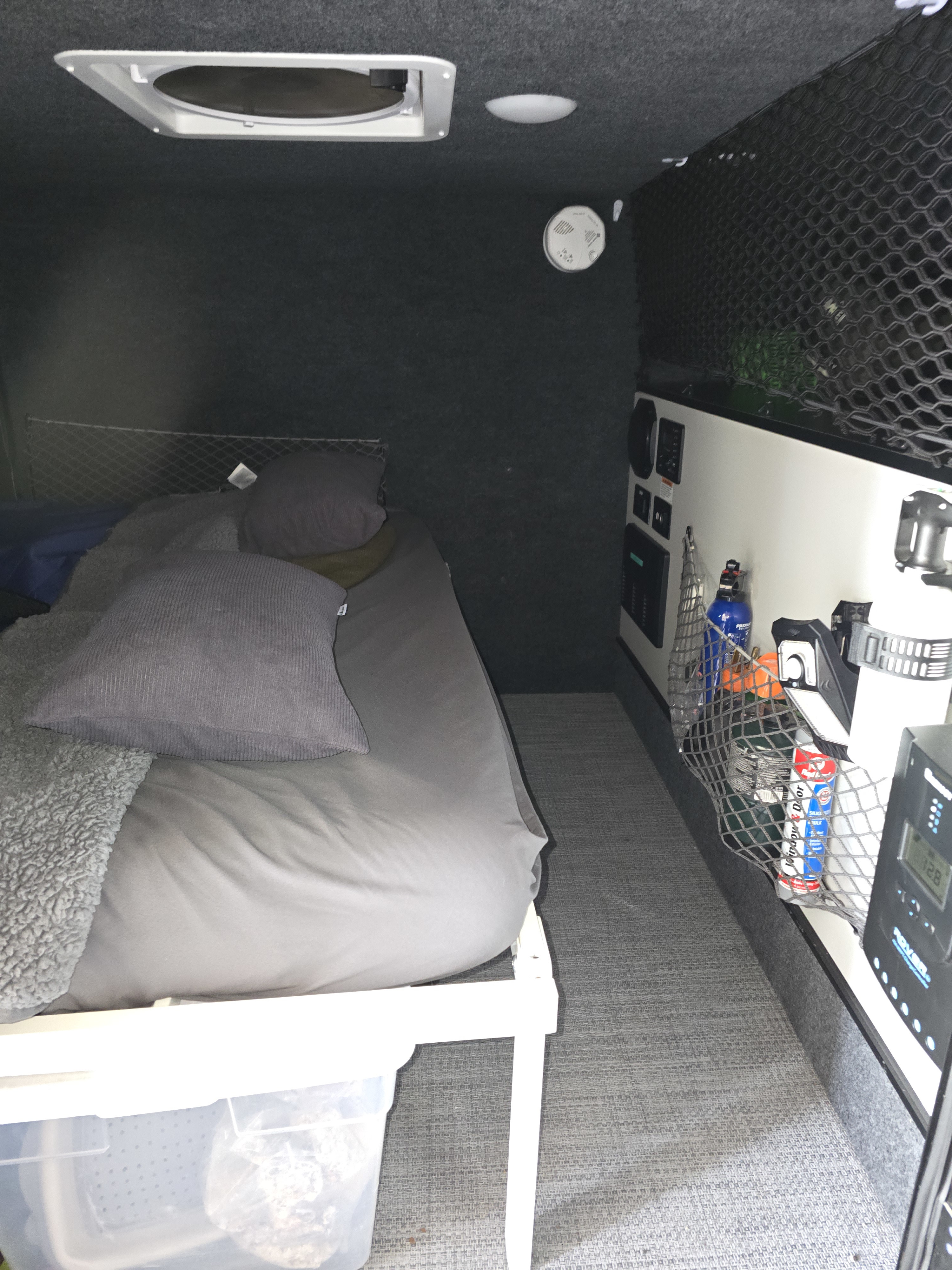 Well-appointed RV rental interior featuring a comfy bed, overhead vent, smart storage, and control panel.. InTech RV InTech RV Trailer 2021