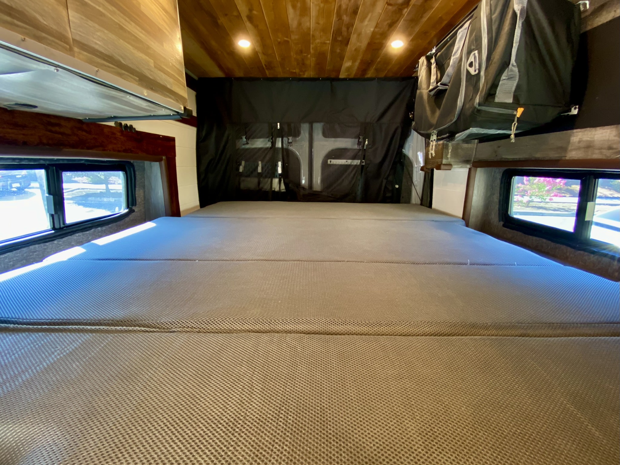 Experience comfort in our RV rental! This full-size bed with mesh cover, side windows & overhead storage is ready.. Ford Transit Transit 2022