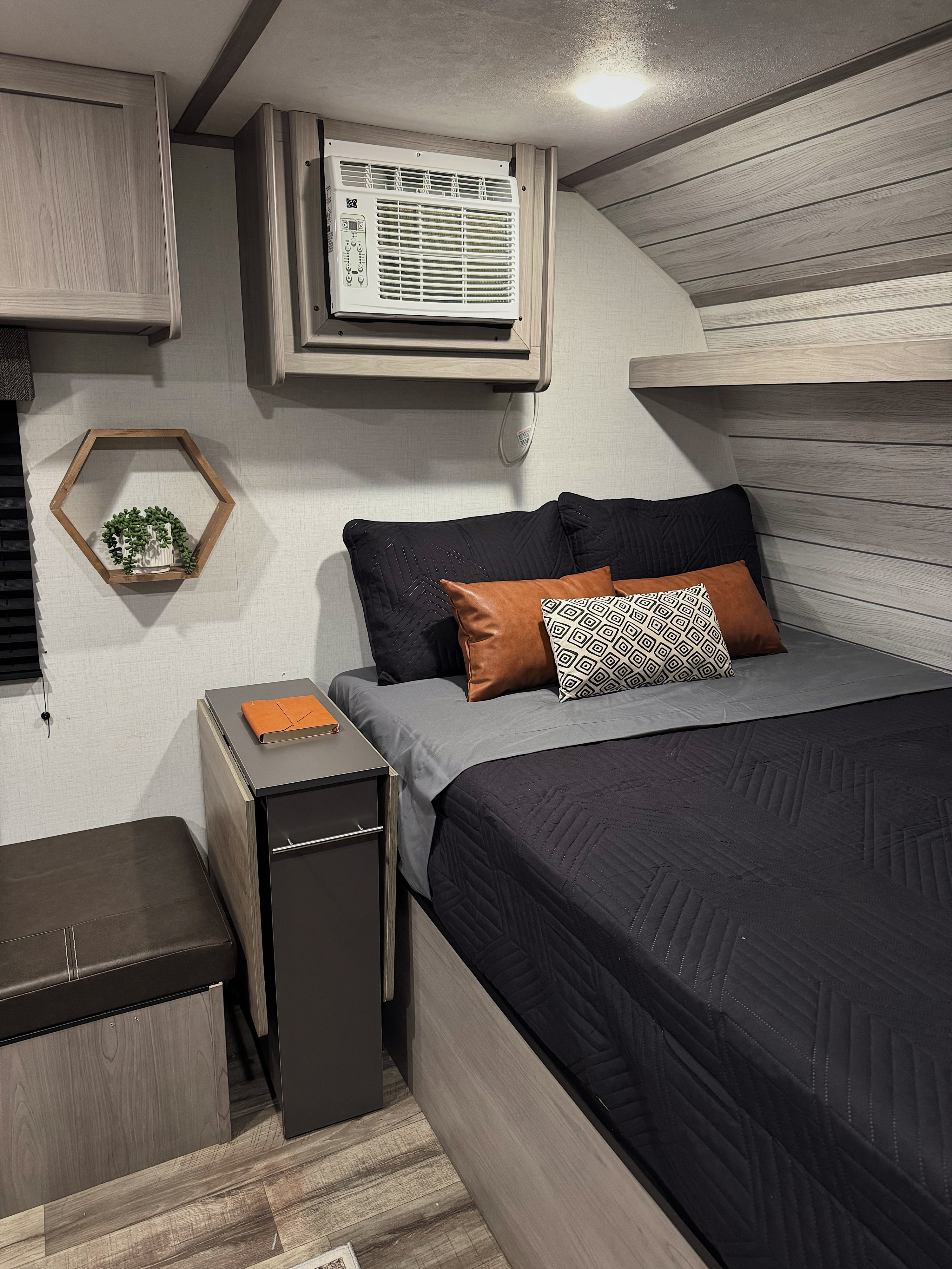 Modern RV rental bedroom with cozy bed, AC, and smart storage. Ideal for travel comfort.. Dutchmen Coleman Lantern LT 2023