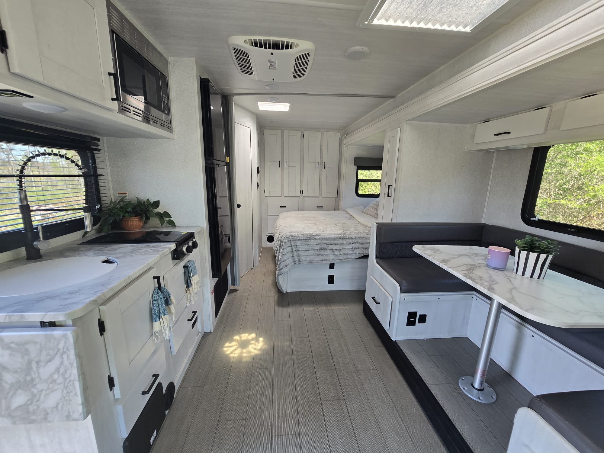 Step inside this bright, well-equipped RV rental! Modern interior with kitchen, bedroom, and dinette ready for your travels.. EAST TO WEST Entrada M-Class 2023