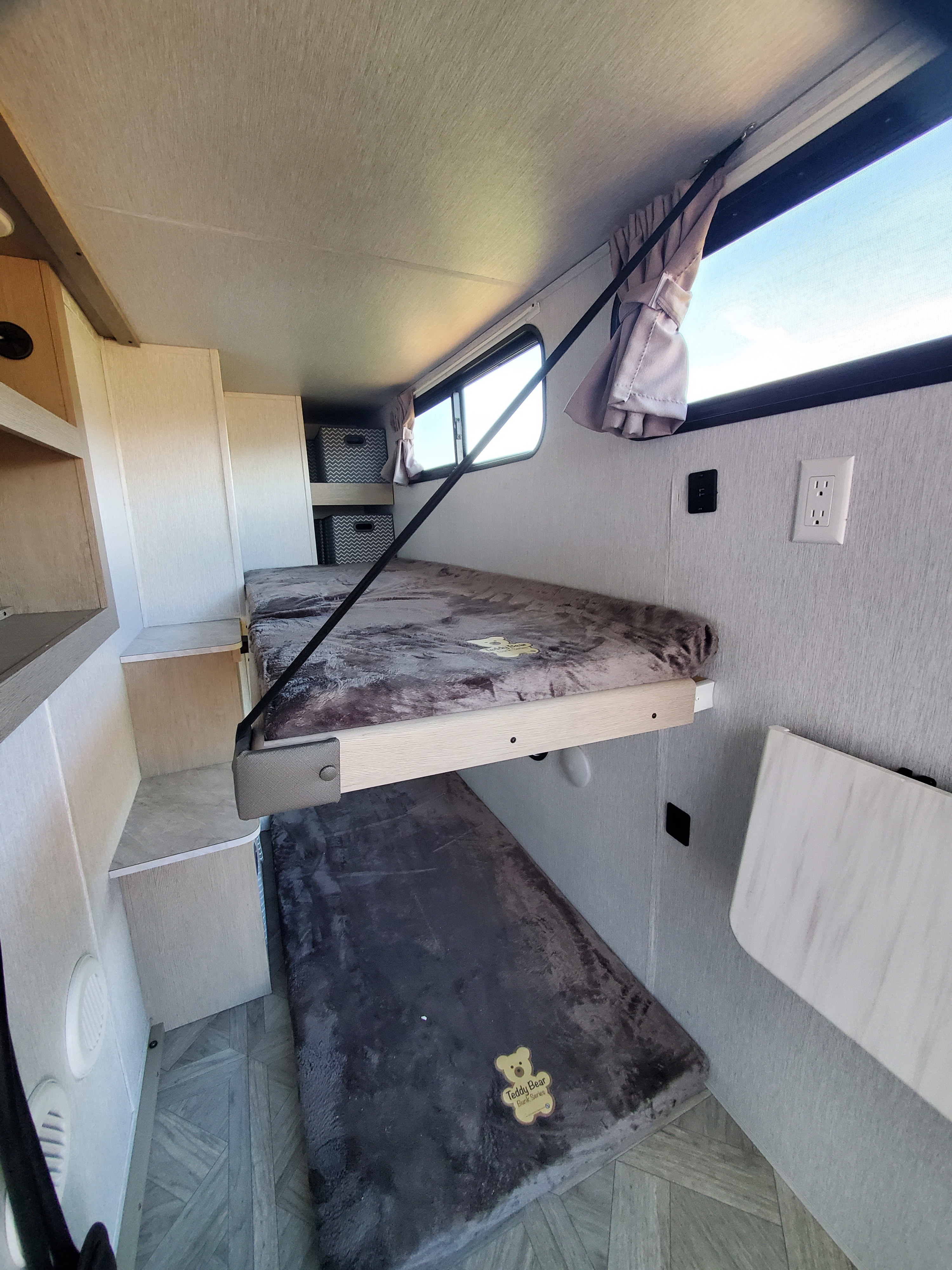 RV rental bunk beds feature cozy fuzzy blankets, built-in shelving, a window, and power outlets for a compact stay.. Forest River Salem Platinum 2024