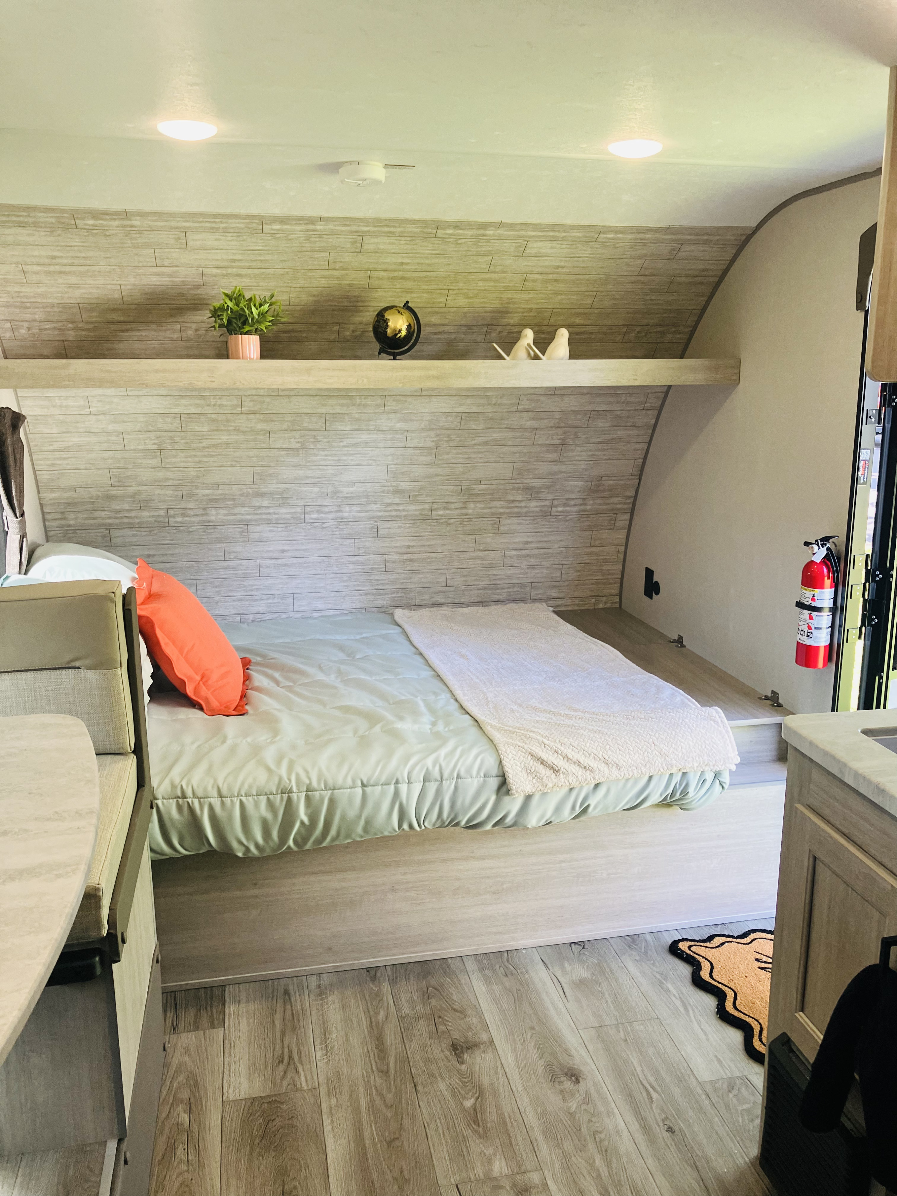 Cozy RV rental interior with a comfy bed, stylish shelving, and a modern dinette for your next adventure.. Coachman 184BHSXTT 2025