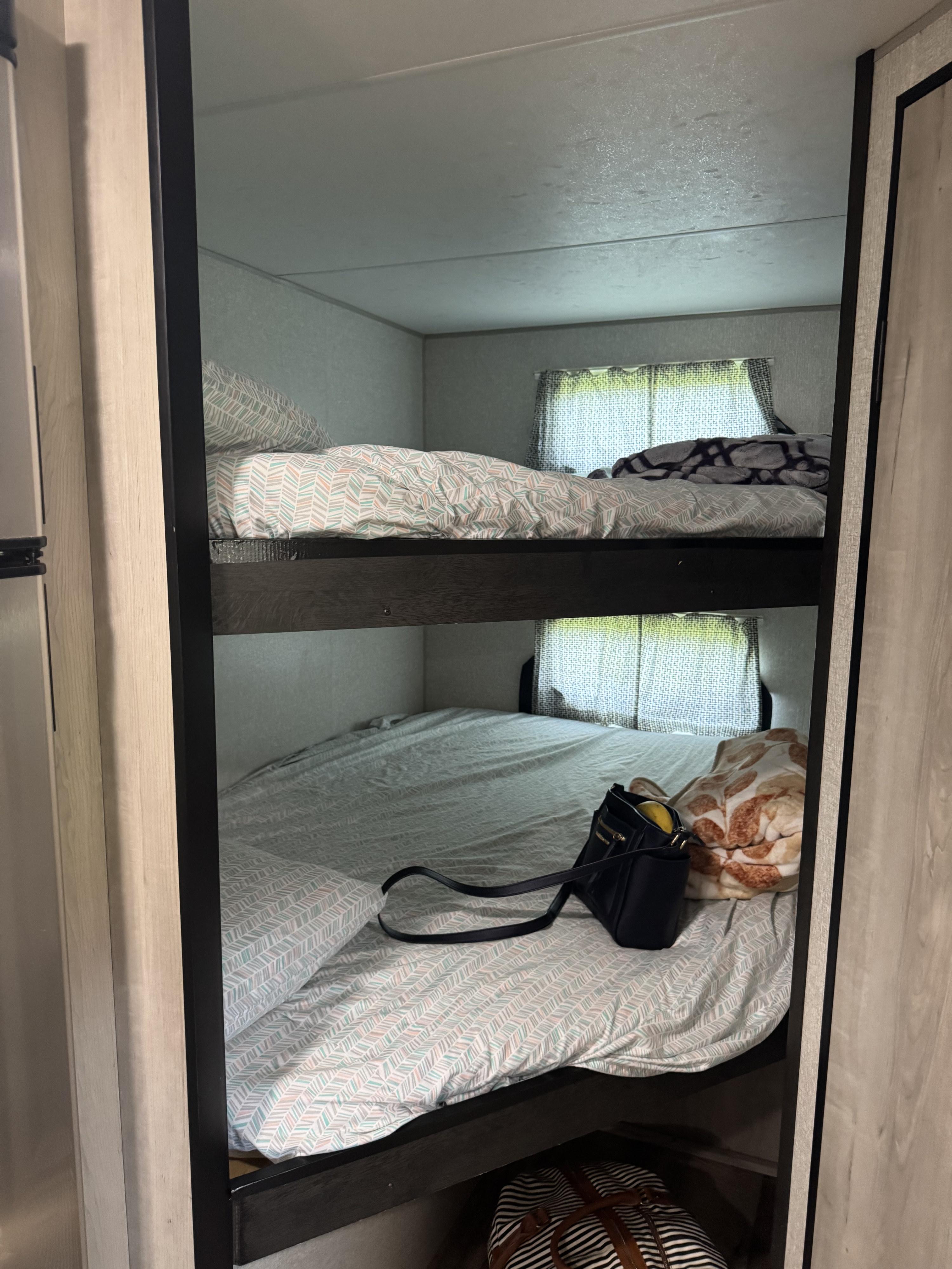 Comfortable bunk beds in this cozy RV rental interior, ready for a good night's sleep on your camper adventure.. K-Z Manufacturing Connect SE 2021