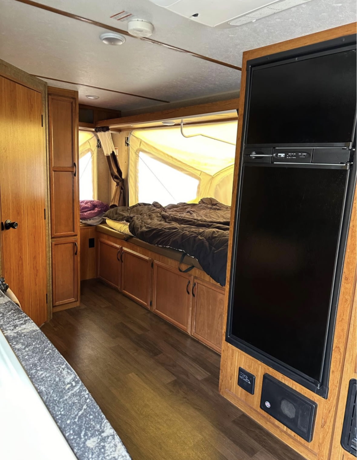 Spacious RV rental interior featuring a large pop-out bed, full-size fridge, and ample storage.. Starcraft TRA 2016