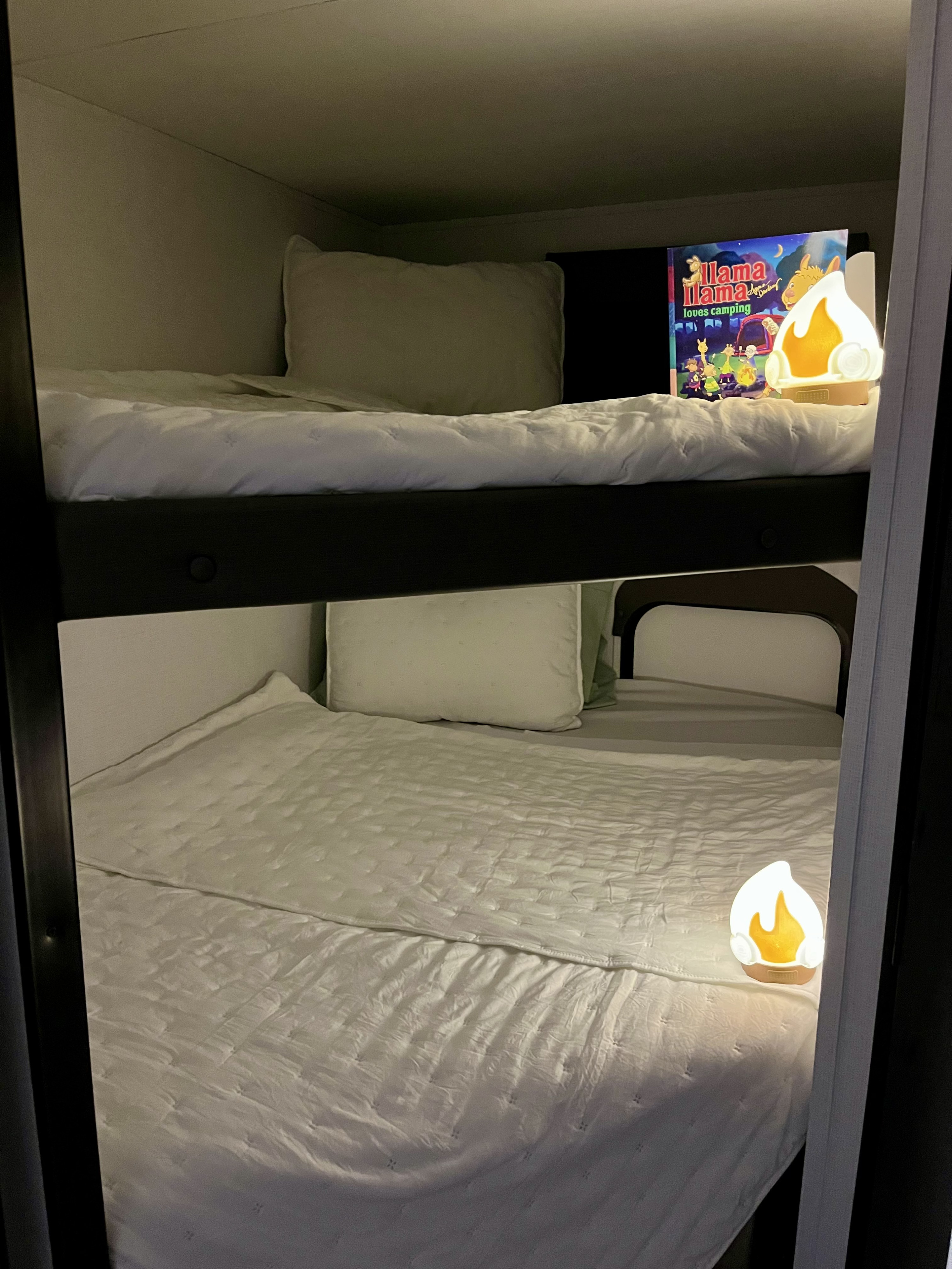 Perfect for kids in an RV rental: cozy bunk beds with a "Llama Llama loves camping" book & bonfire nightlights.. Keystone RV Hideout 2023