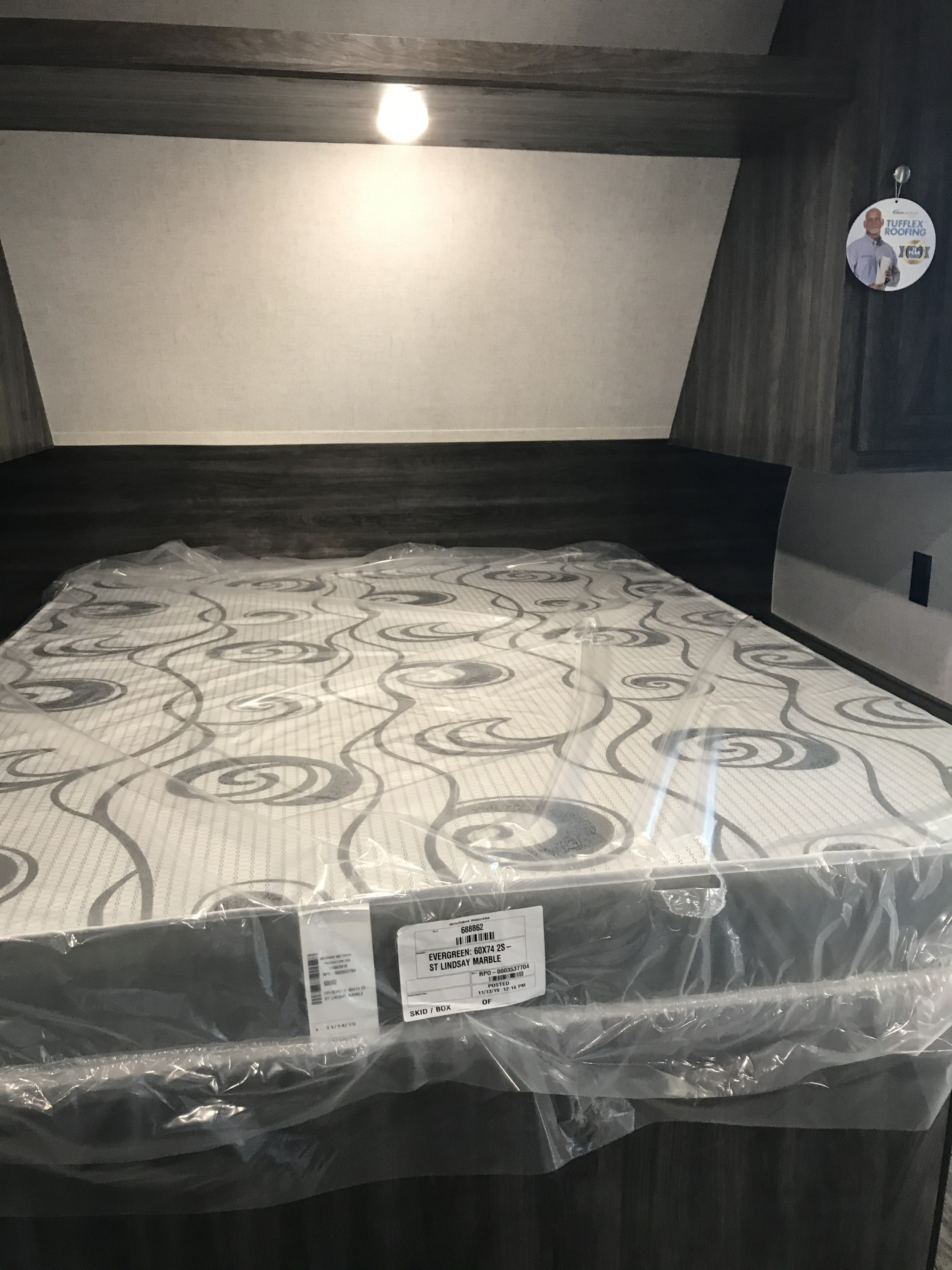 Ready for your RV rental: a new Evergreen 60X74 RV bed, still wrapped in plastic inside a modern camper.. Highland Ridge RV Open Range 2020