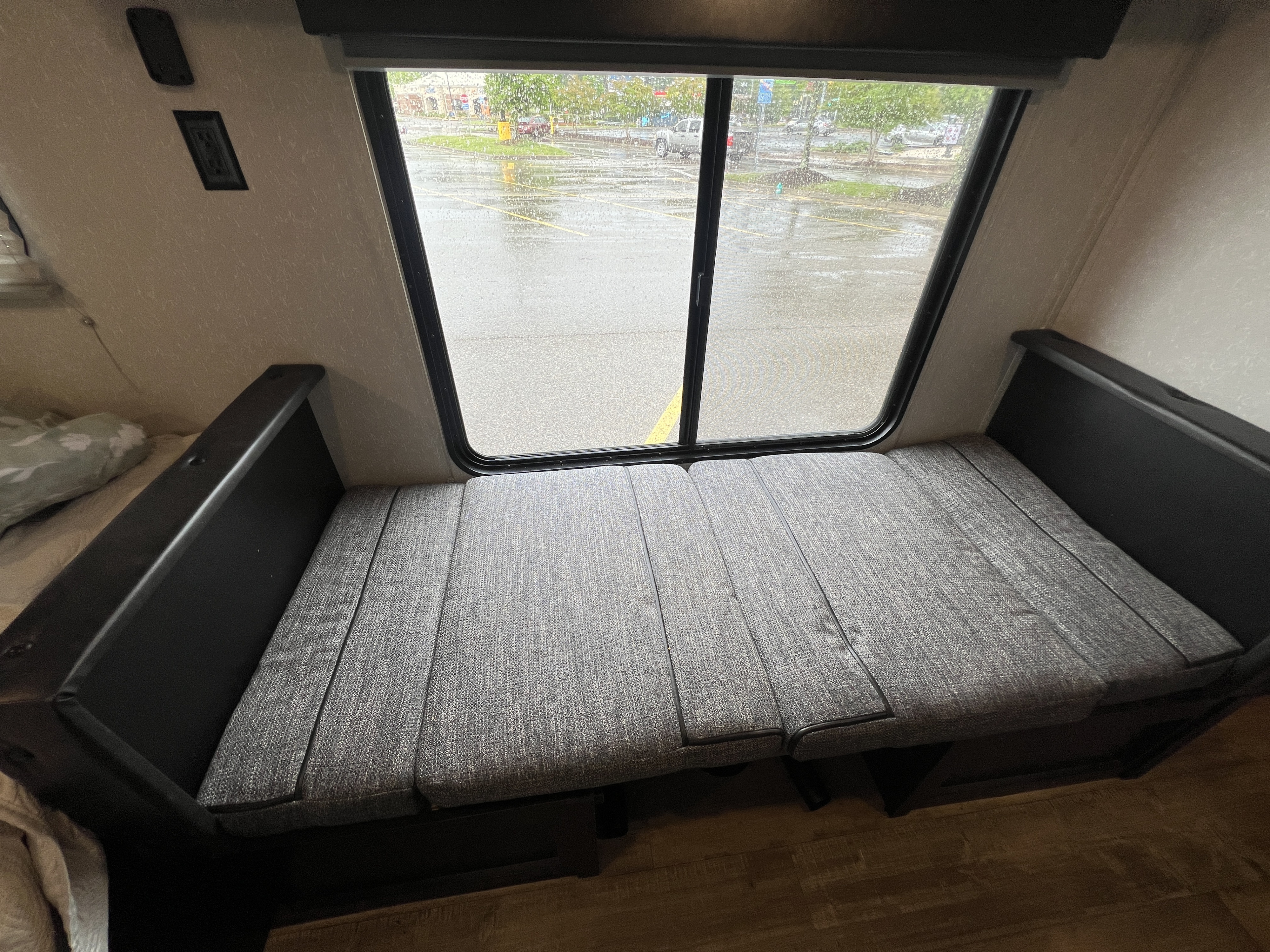 Comfortable RV rental interior: a versatile bench dinette with window view, perfect for relaxing or sleeping during your travels.. Forest River Cherokee Wolf Pup 2021