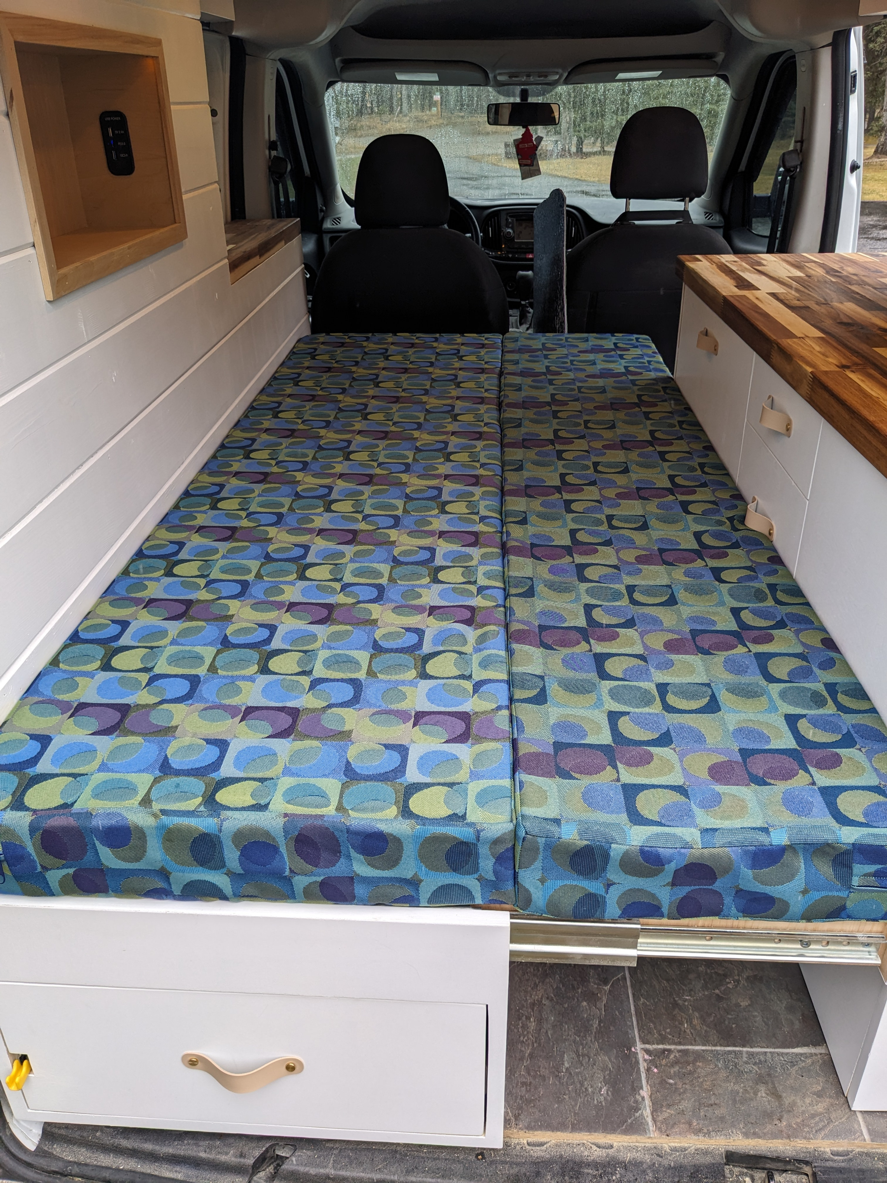 Cozy RV rental: Van conversion featuring colorful modular bed, built-in storage, and USB power station.. Dodge Sprinter Van 2015