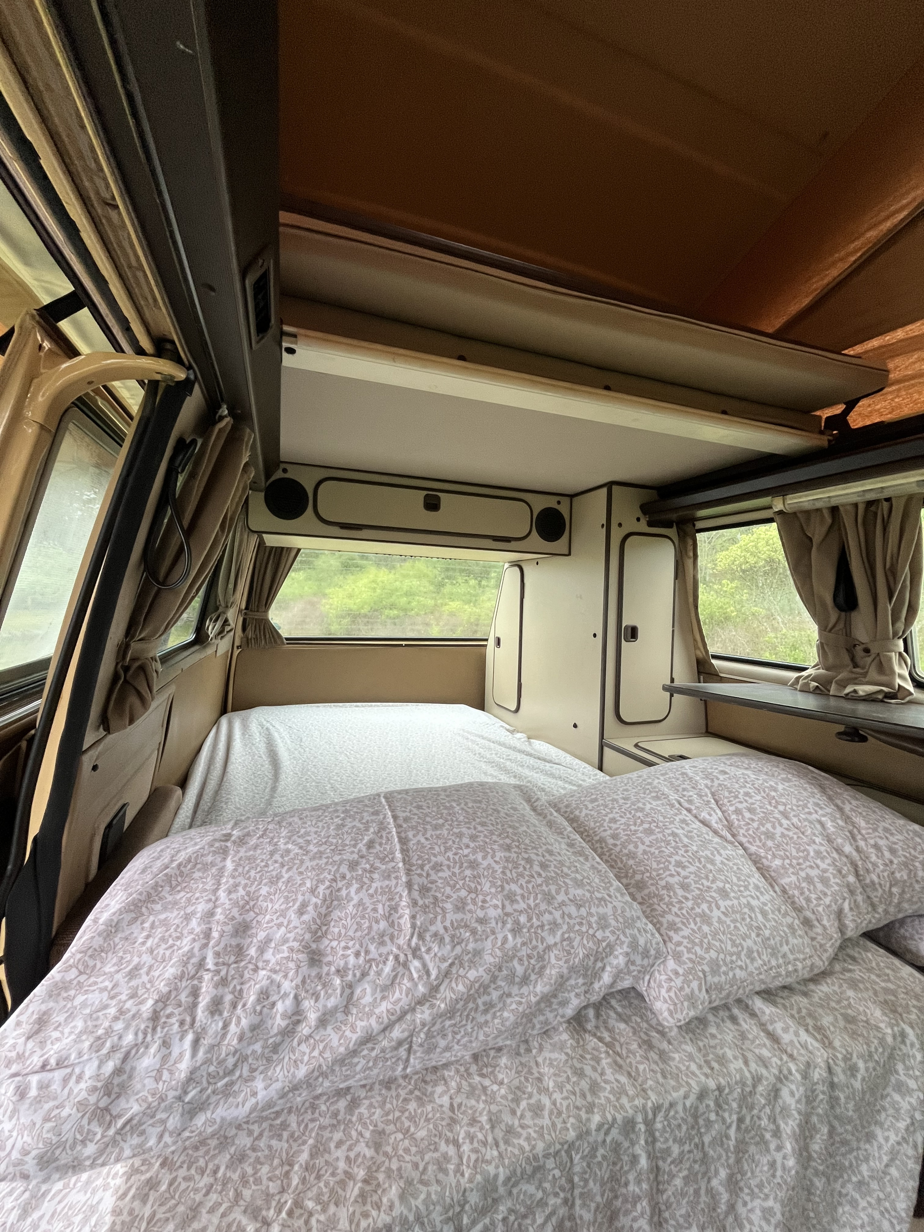 Comfortable RV rental camper interior with two beds and a pop-top, ready for sleeping amidst nature.. Volkswagen Westfalia 1985