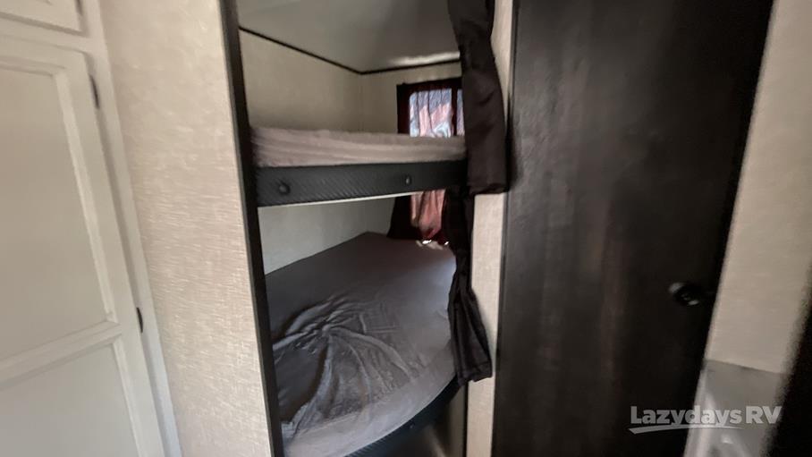 Inside an RV rental: two bunk beds with dark bedding, perfect for family adventures or camping trips.. Jayco Jay Flight SLX 8 2021