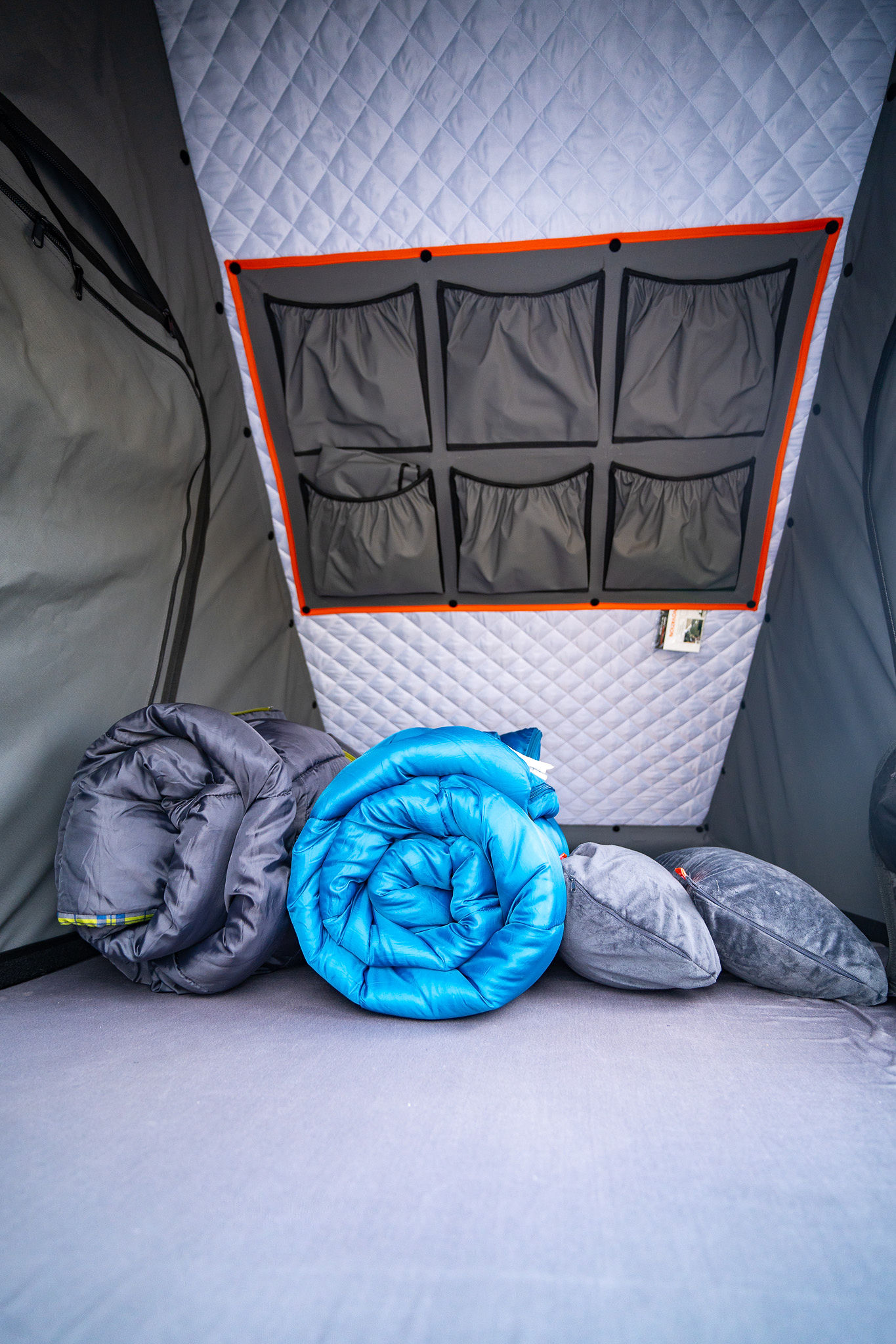 RV rental ready: A comfy interior with quilted walls, storage pockets, two rolled sleeping bags, and pillows for your adventure.. Toyota Tacoma TRD Pro 2021