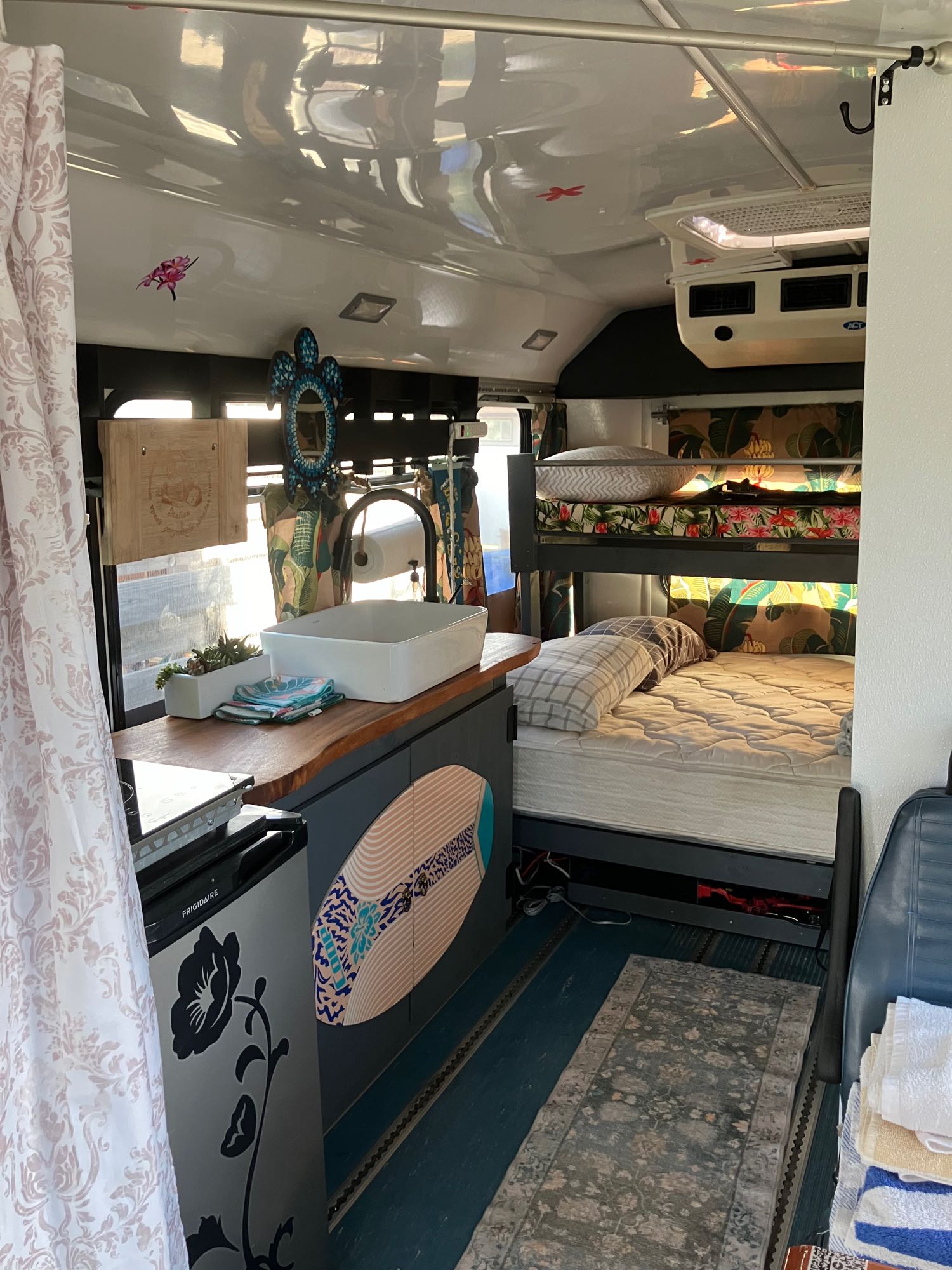 This RV rental offers a compact kitchen with sink & fridge, plus comfy tropical-themed bunk beds. Ideal for travel.. Ford E450 2014