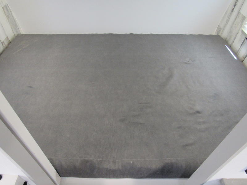 RV rental's elevated sleeping area: a gray textured mat or pad, viewed from above.. Travel Lite Rove Lite 2024