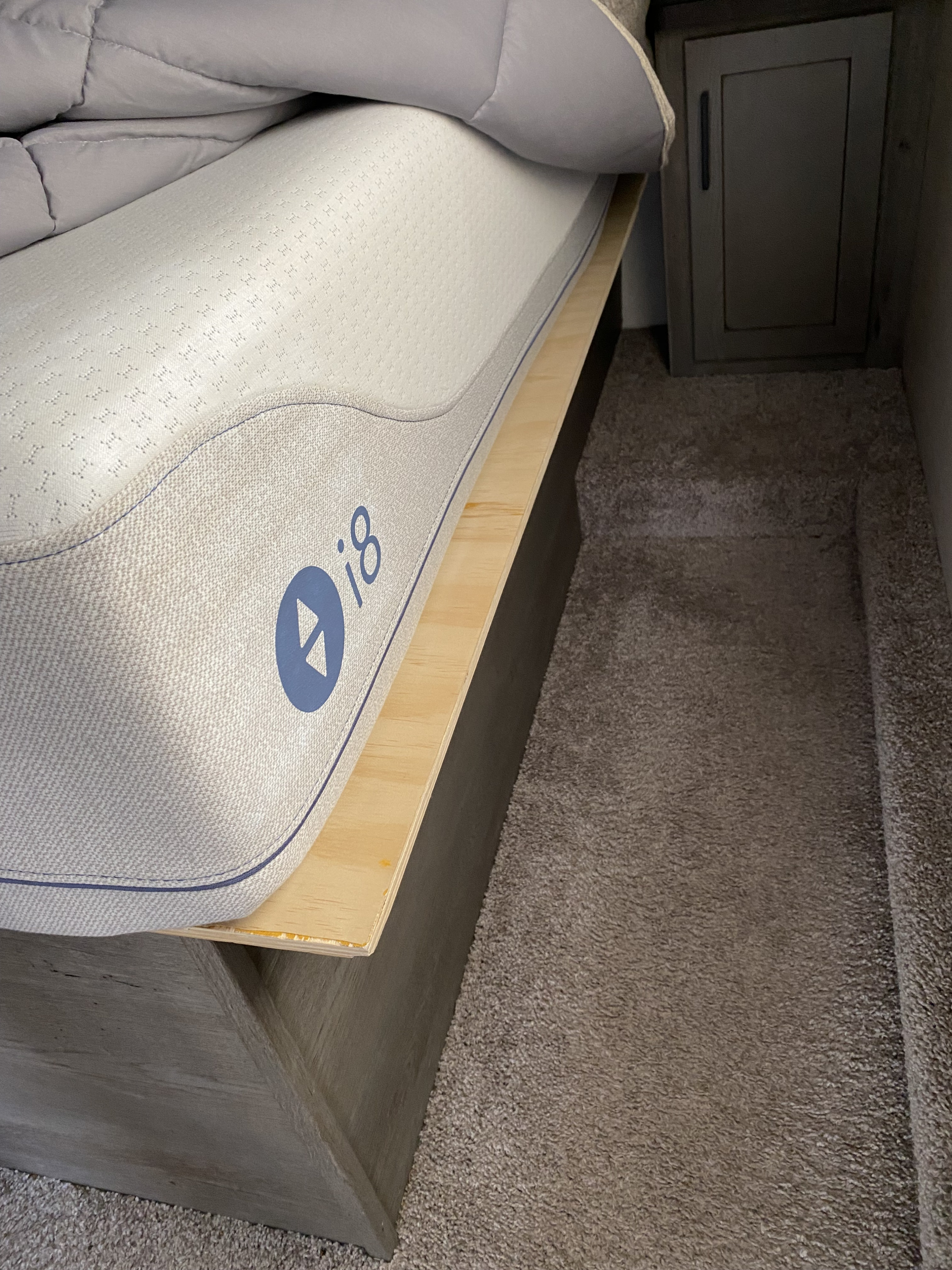 RV rental: Sleep Number i8 mattress on wood bed base, grey comforter, carpet, and cabinet.. Keystone Carbon 2020
