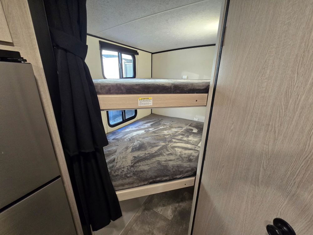 Compact bunk beds inside this RV rental provide comfortable sleeping, complete with individual windows.. Coachmen Apex Nano 208BHS 2023