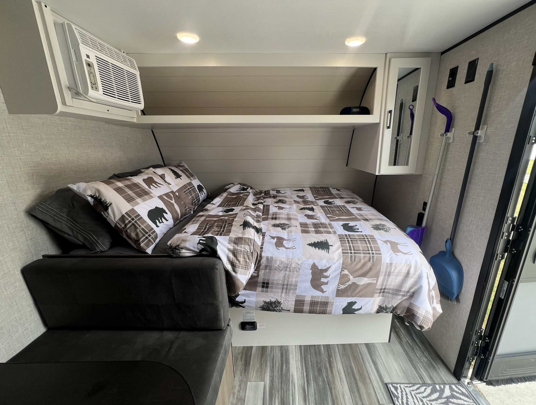 Inside a cozy **rv rental**: compact bedroom with bear-themed bedding, a sofa, and an AC unit for comfortable travel.. Jayco Jay Flight SLX 170BHW 2025