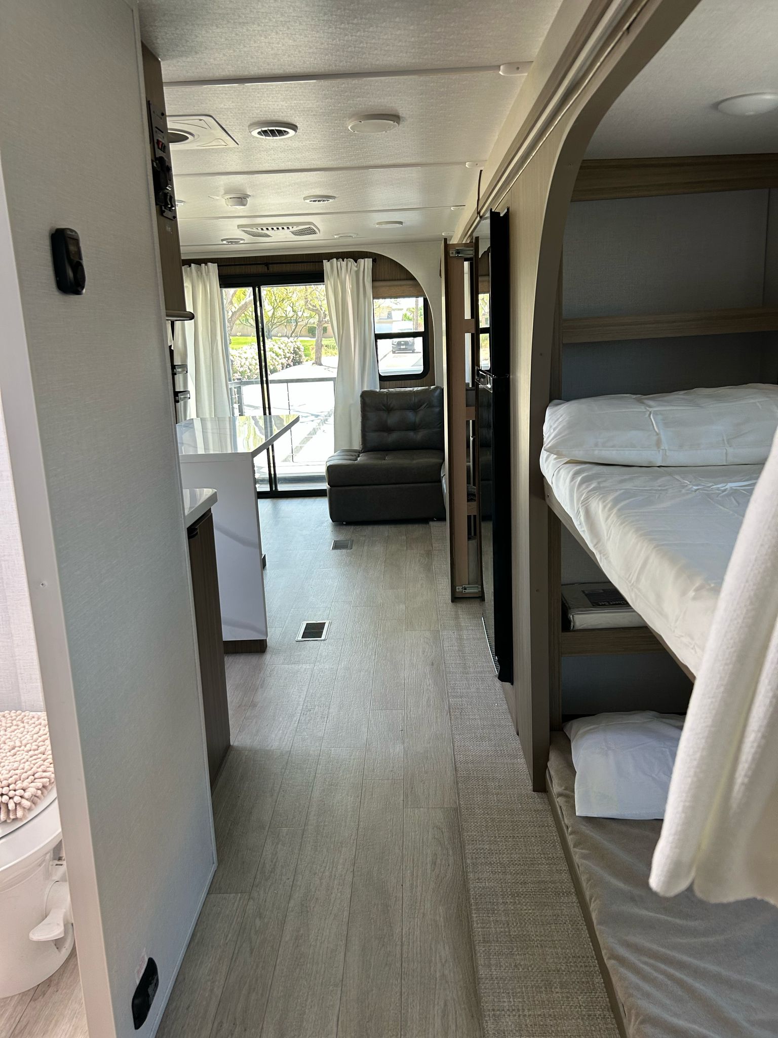 Tour this modern RV rental interior! Features bunk beds, a sleek kitchen, and a cozy living area with large windows.. Forest River RV 34VERANDA 2025