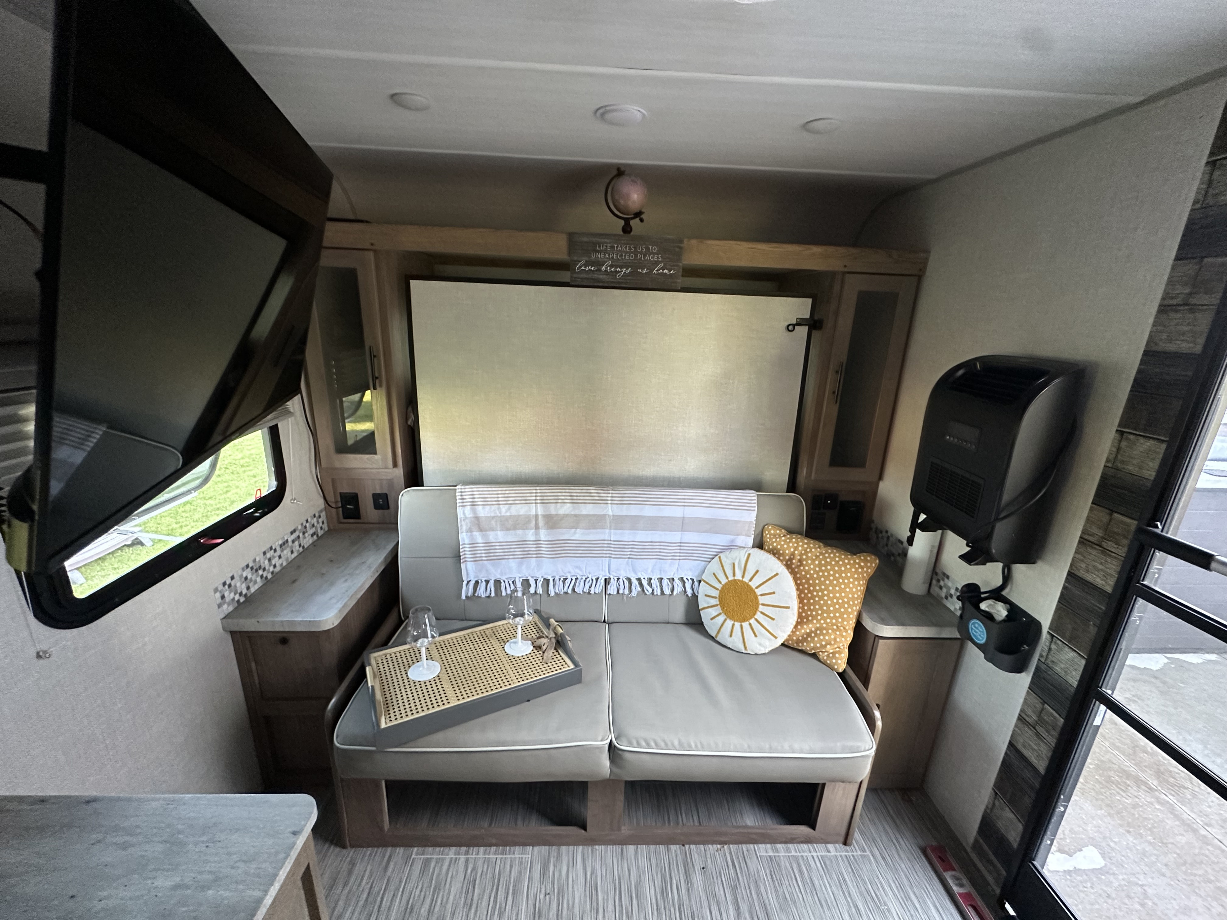 Explore this inviting RV rental interior: sofa, TV, and thoughtful touches for a comfortable mobile living space.. No Boundaries 19 2022
