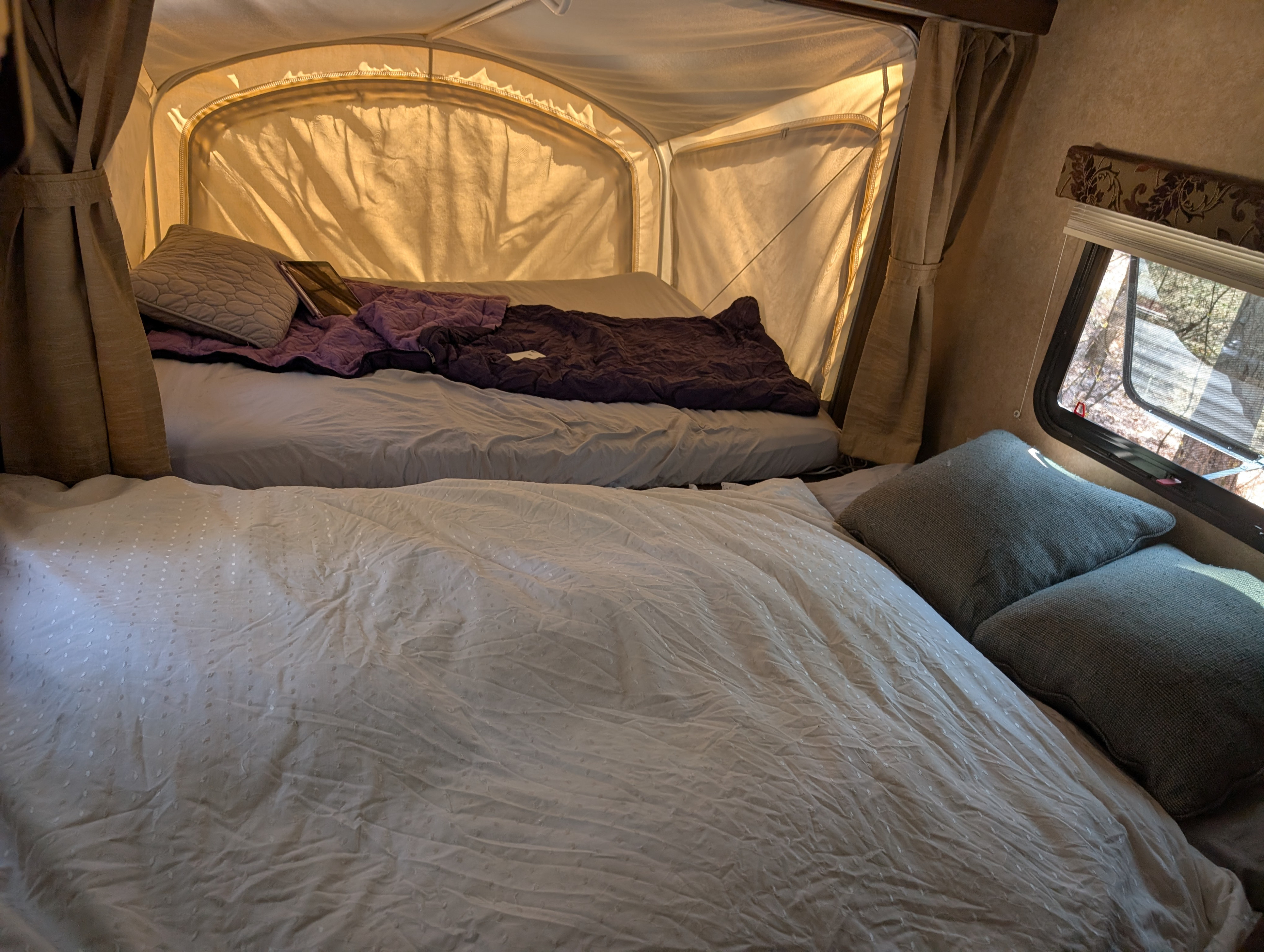 Cozy rv rental interior with two beds, one in a pop-up tent extension. Perfect for camping adventures.. Starcraft AR-One 2014