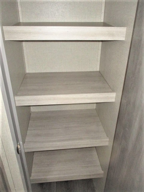 Light-toned shelves inside an RV rental cabinet, ideal for organizing belongings during travel.. Forest River Coachmen Catalina Legacy 2022