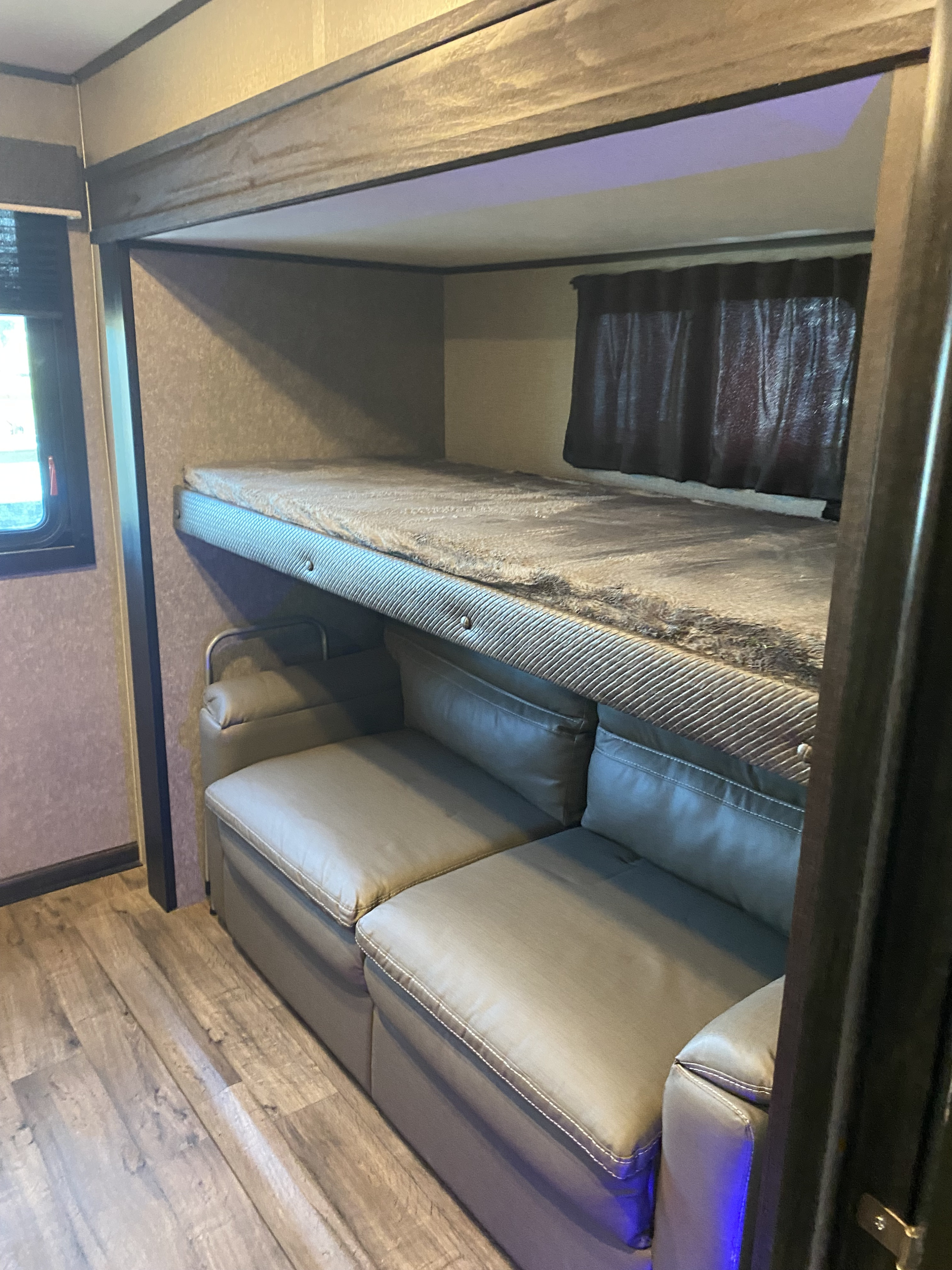 RV rental with cozy bunk beds above a soft sofa, plus modern under-lighting. Great for family trips!. Jayco Eagle HT 2021