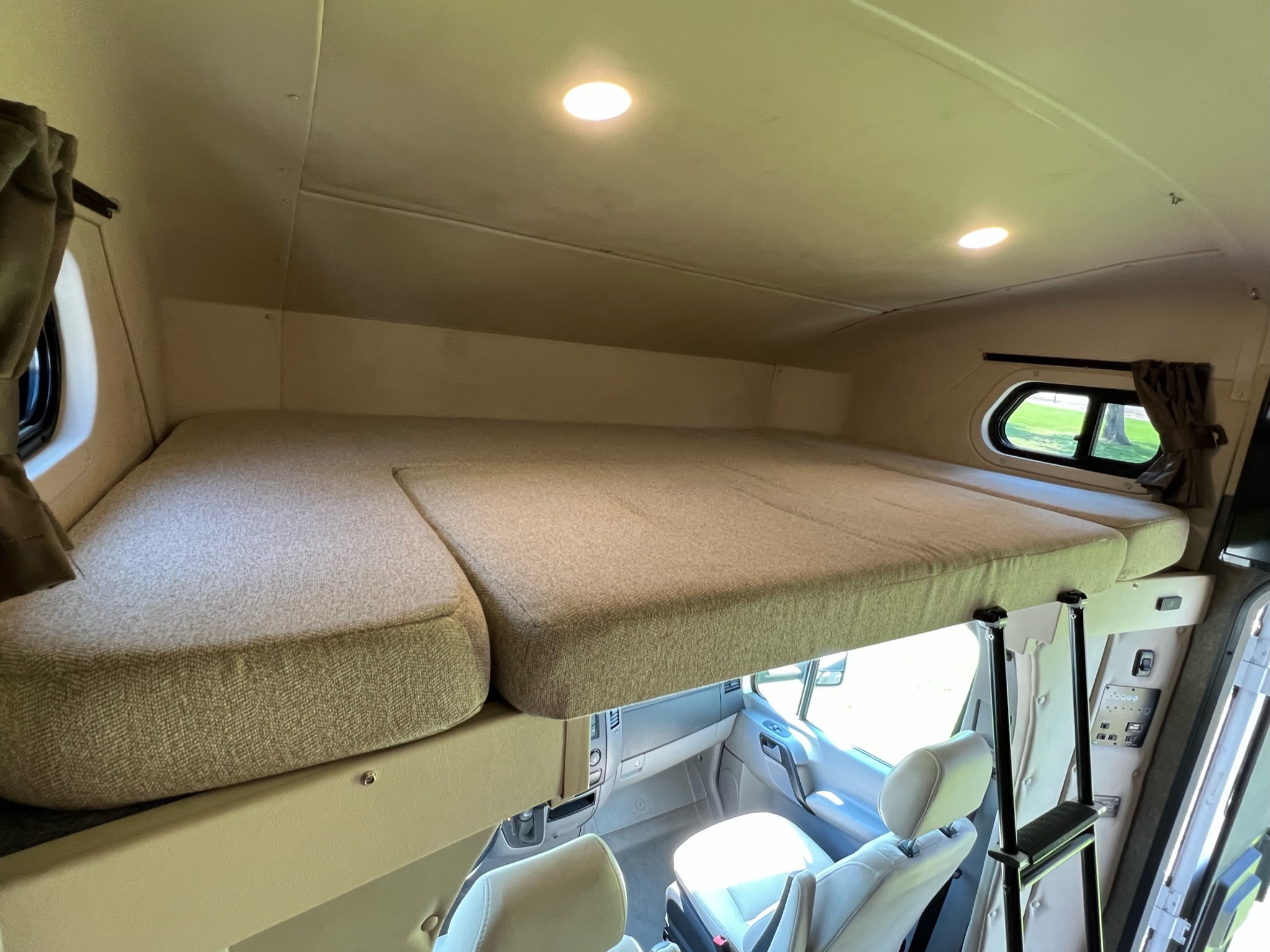 Spacious, comfortable cab-over bunk in this RV rental, with a ladder for easy access.. Holiday Rambler Prodigy 2018