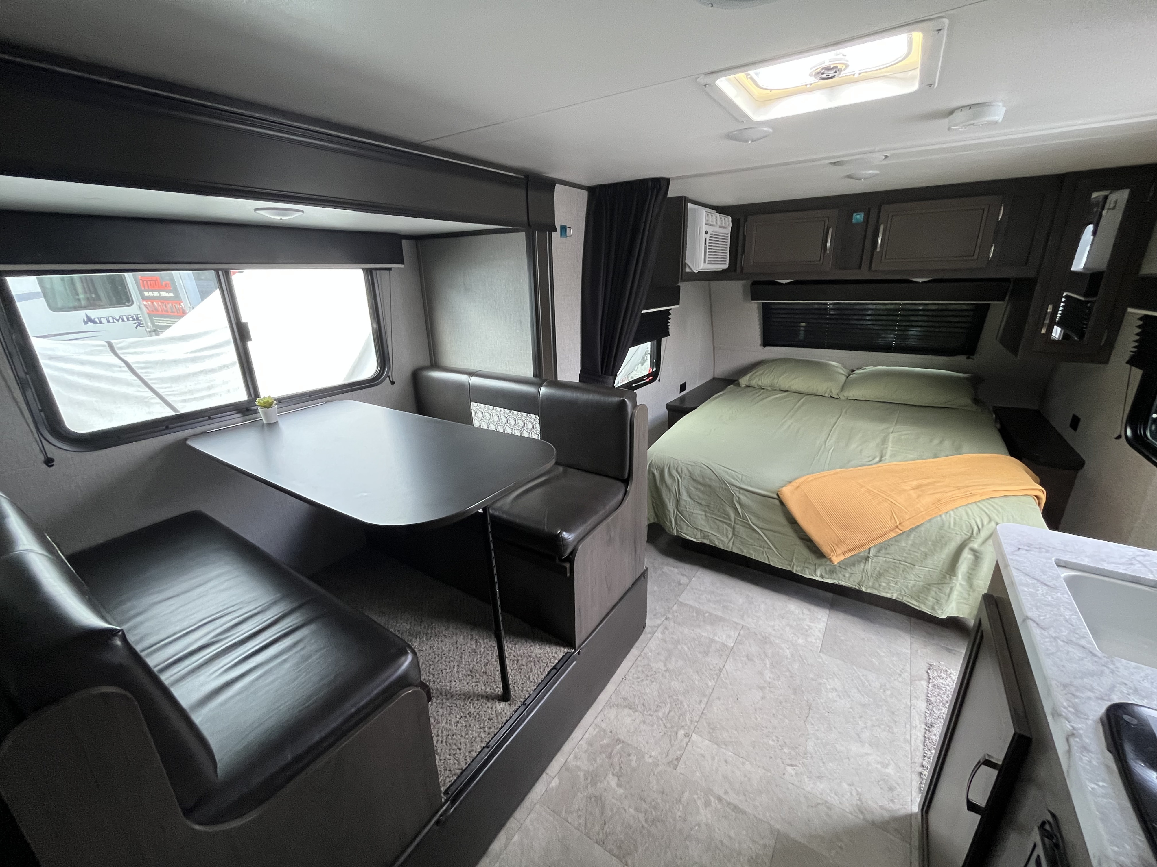 Spacious RV rental interior with dinette, comfy bed, and kitchenette, perfect for your next road trip adventure.. Jayco Jay Flight SLX Baja Edition 2020